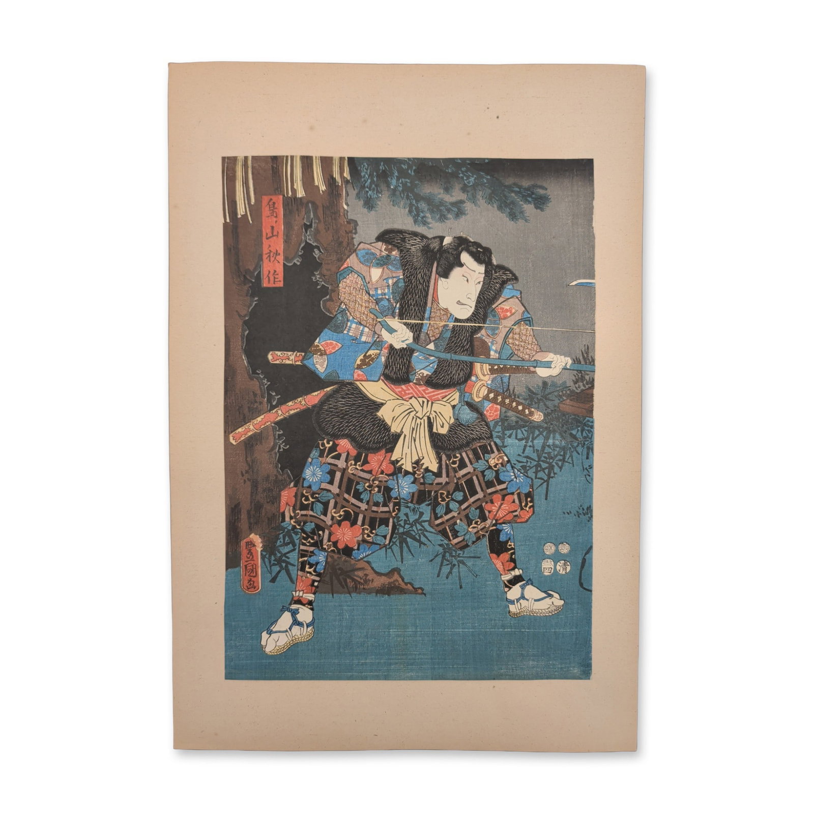 Utagawa Kunisada (Toyokuni III) (Japanese, 1786-1865) Woodcut on Paper of a Kabuki Actor Warrior: A 19th-century Japanese color woodblock print depicting a single Kabuki actor portraying an armed warrior in a powerful martial stance outdoors, holding a bow horizontally with both hands. The figure 
