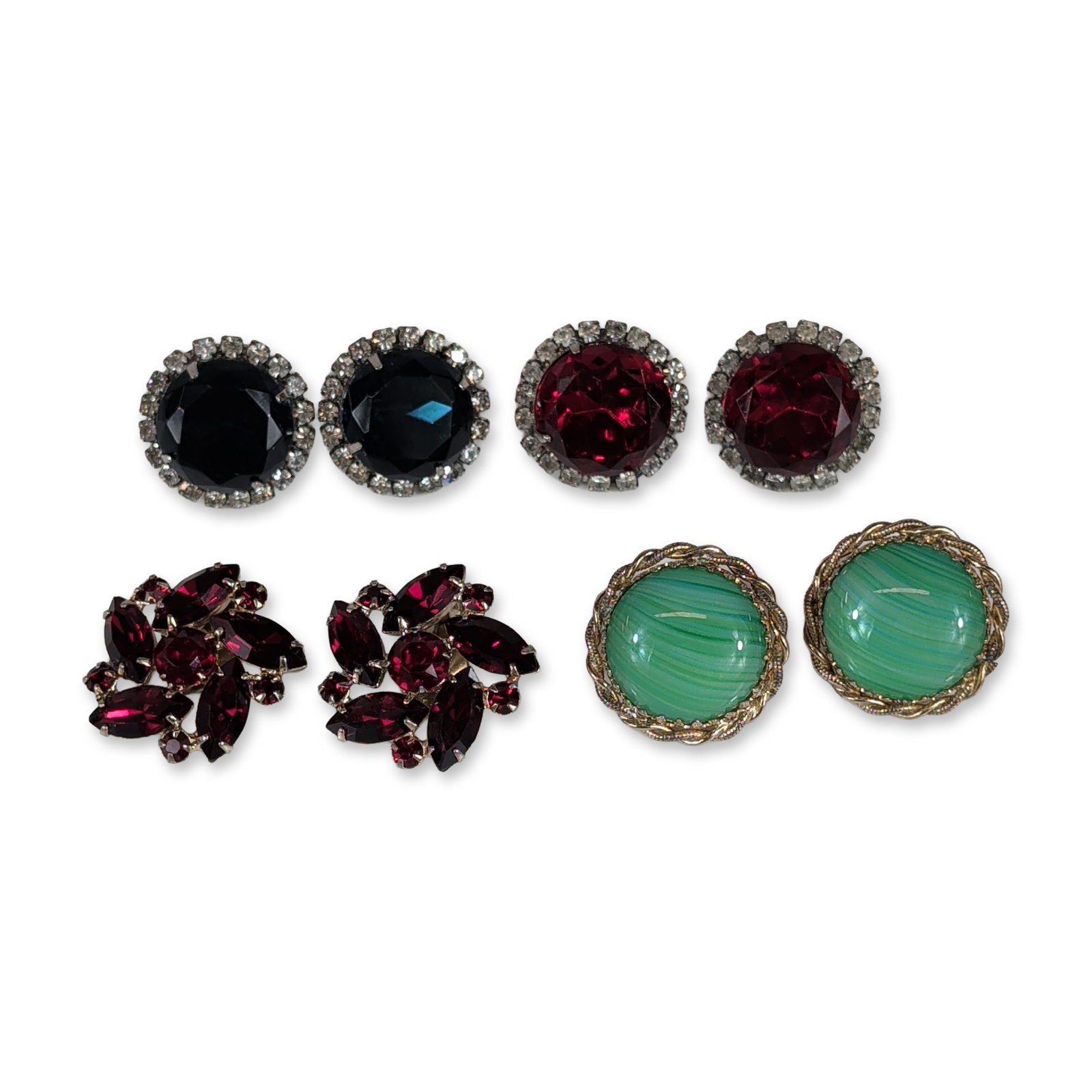 Assortment of Vintage Mid-20th Century Costume Jewelry Earrings: Group of four pairs of vintage mid-20th-century costume jewelry earrings. The lot includes a pair of Sarah Coventry gold-tone earrings featuring green marbled glass cabochons in a twisted-rope border,