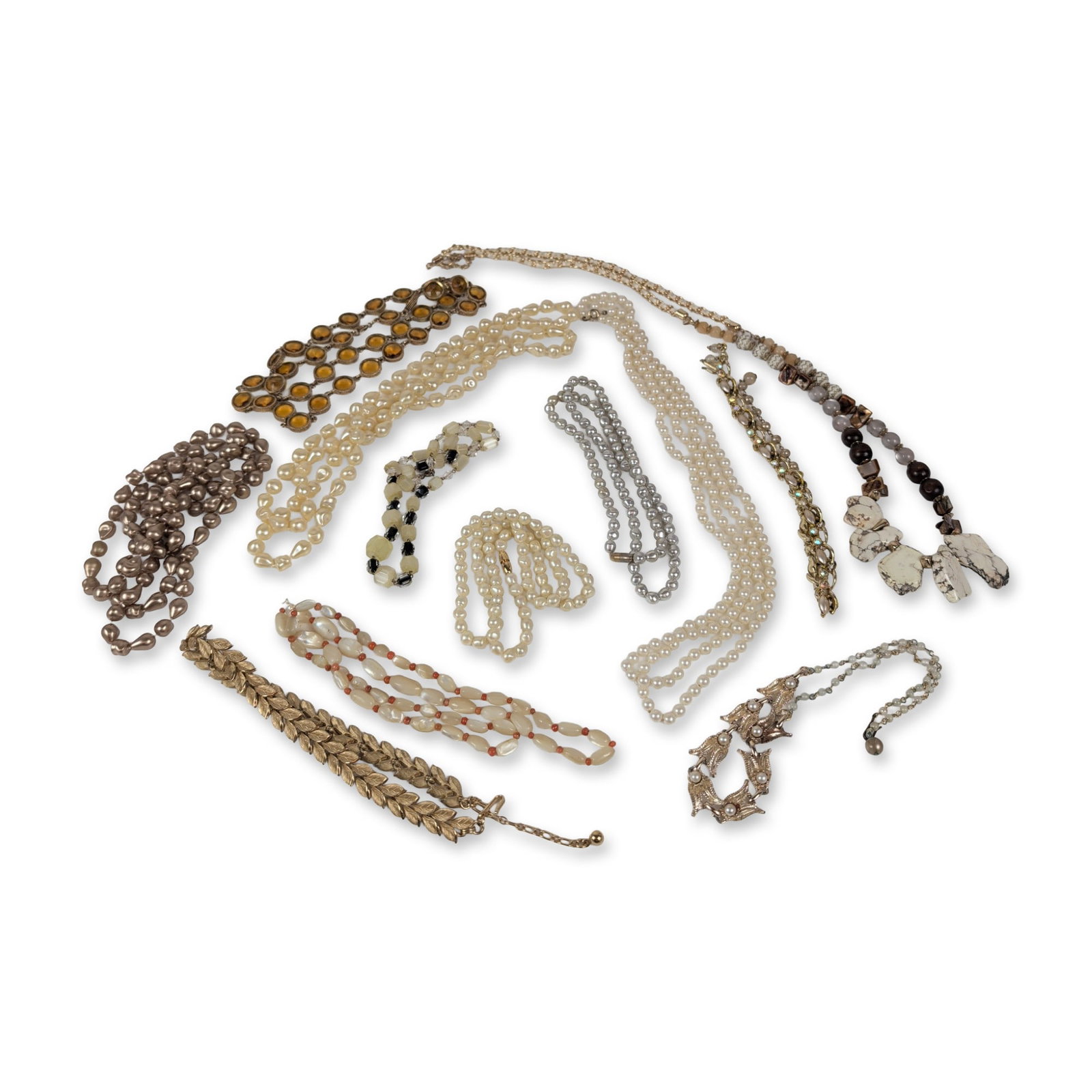 Collection of Vintage Faux Pearl and Beaded Costume Jewelry: Mid-century style. Collection of costume jewelry in base metals and assorted materials, featuring multi-strand faux pearl necklaces in cream, metallic brown, and silver tones. The group includes an am