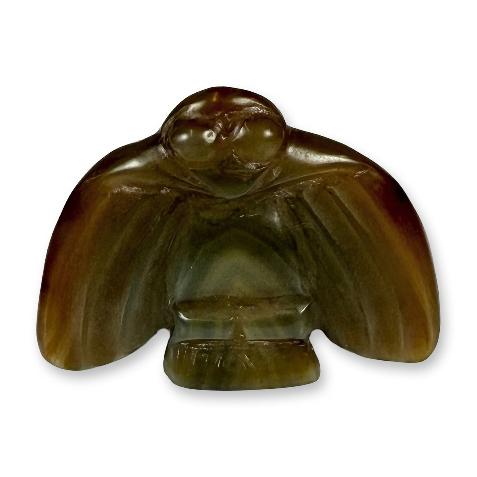 Chinese Archaistic Carved Yellow-Brown Bird Pendant: This carved yellow-brown bird/winged creature pendant is crafted from variegated nephrite jade in the style of the Neolithic Hongshan culture. The stone exhibits a range of natural colors from olive g