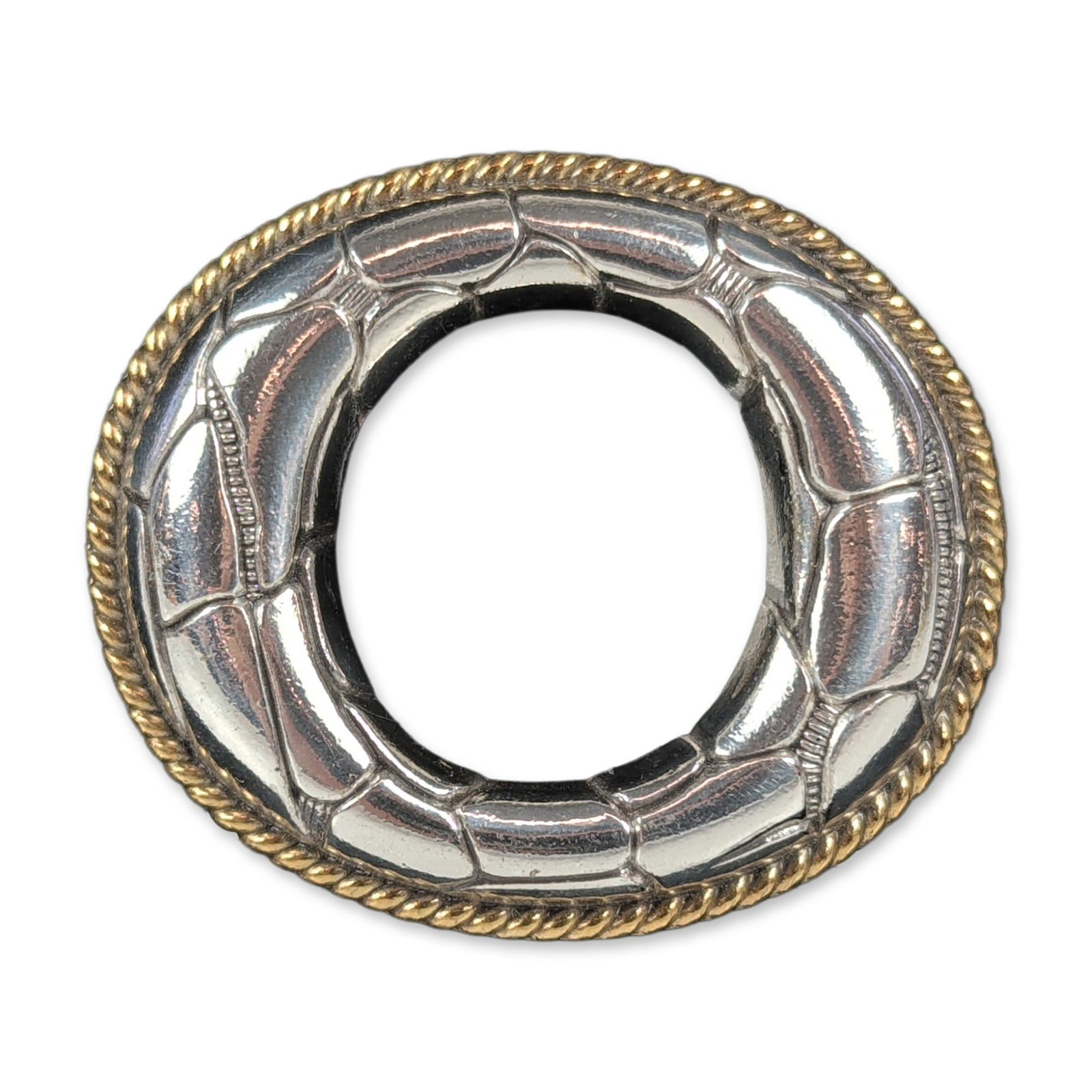 Terry Stack Two-Tone Belt Buckle: Terry Stack (1998), belt buckle in two-tone silver and gold-tone metal, featuring a textured scalloped center and rope border, marked TERRY STACK and copyright 1998 on reverse, presented on original d