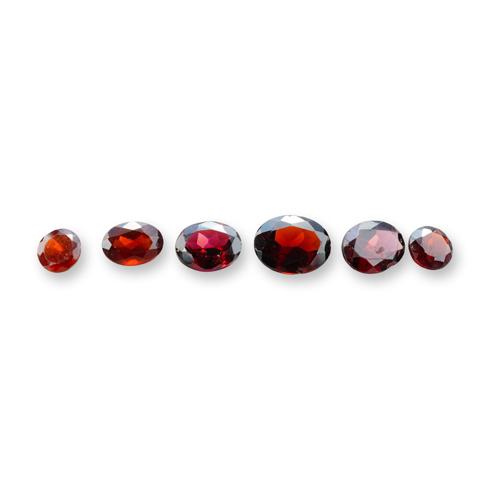 6pc Red Garnet Gemstones in Vatious Shapes and Sizes: Grouping of 6 garnet gemstones. The spiritual meaning of a garnet centers on vitality, protection, and devotion. Known as a stone of passion and commitment, it is highly valued for grounding