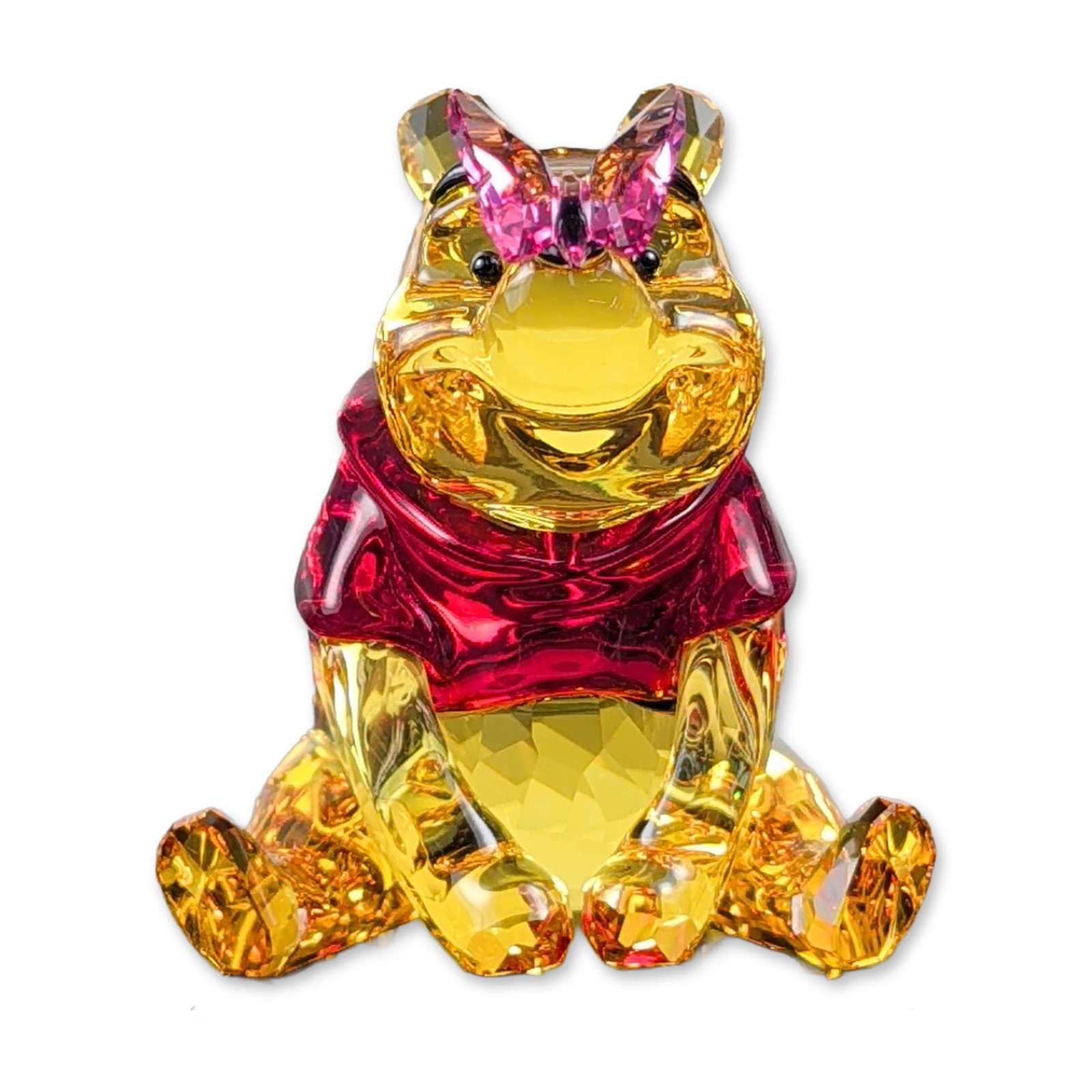 Swarovski Crystal Disney Winnie Pooh with Butterfly Figurine: Swarovski Disney Winnie the Pooh with Butterfly faceted crystal figurine, model 82928. The piece is rendered in amber-toned crystal with a ruby shirt and a rose-colored butterfly perched on the snout.