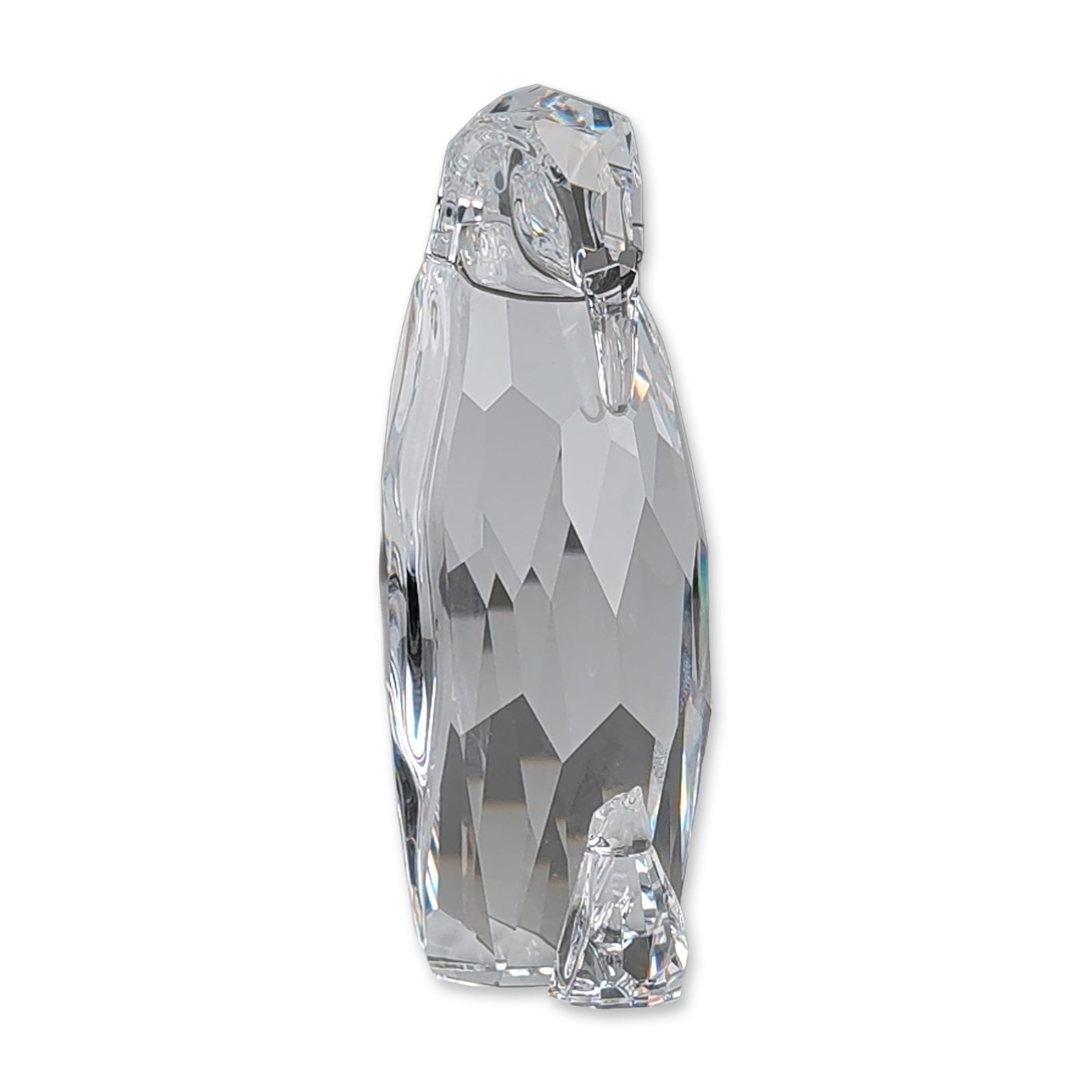 Swarovski Silver Crystal Figurine, Mother Penguin with Baby: Mother Penguin and Baby crafted in faceted clear lead crystal. The stylized animal figure is depicted in a standing posture with baby at her feet. Features the etched Swarovski swan logo on the base. 