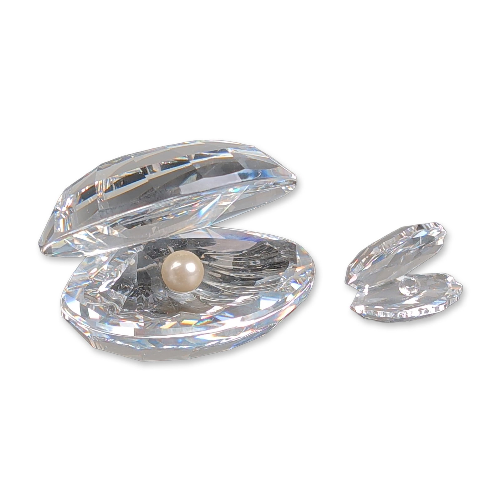 2pc Swarovski Crystal Shell with Pearl Figurines: Swarovski Austrian faceted clear lead crystal figurines depicting open oyster shells, each containing a single cream colored simulated pearl. One large and one miniature example, both featuring the ch