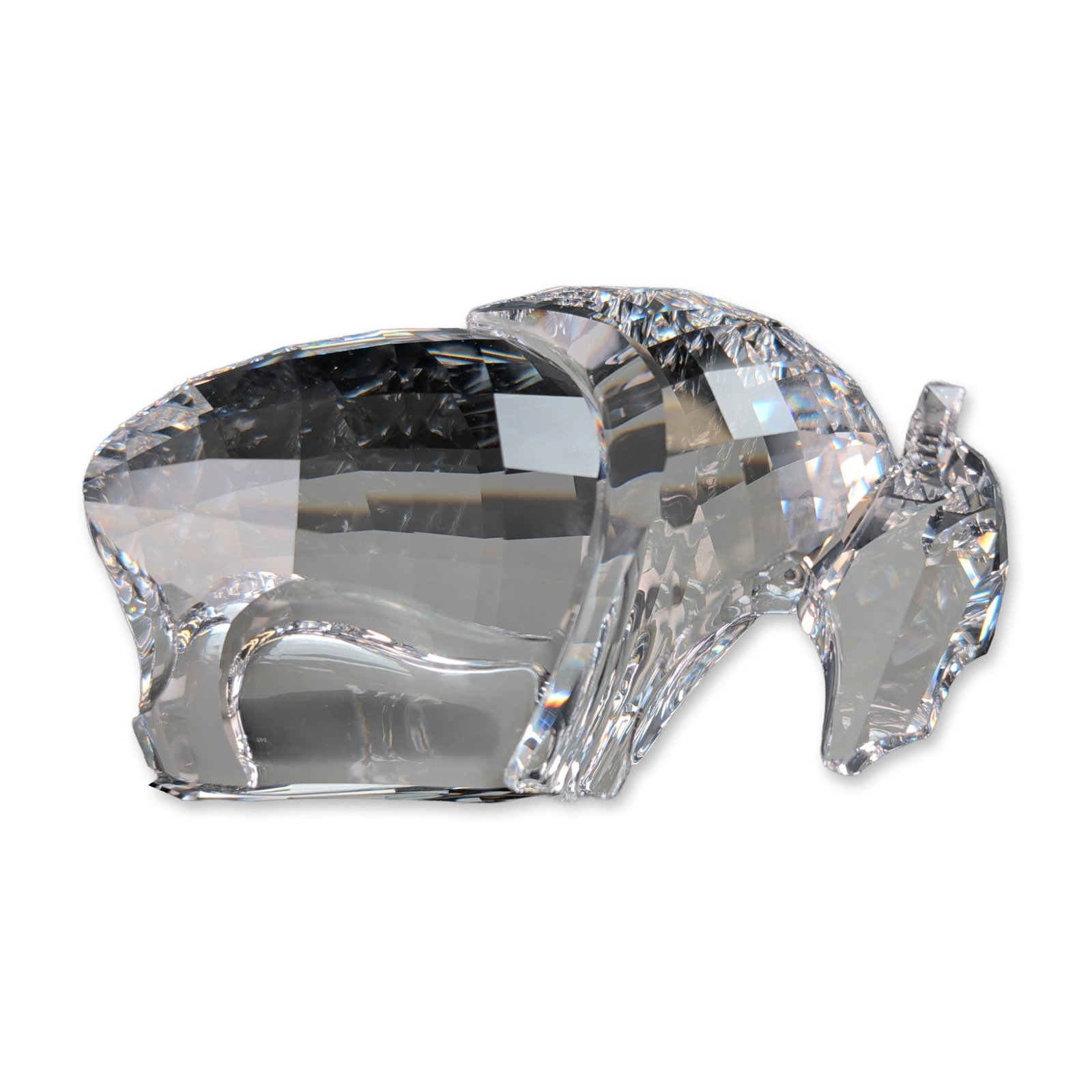 Swarovski Faceted Clear Crystal Buffalo Figurine: Swarovski clear lead crystal figurine titled The Buffalo, featuring a stylized multifaceted body and horns with a smooth polished snout and face. The geometric design is constructed to emphasize light