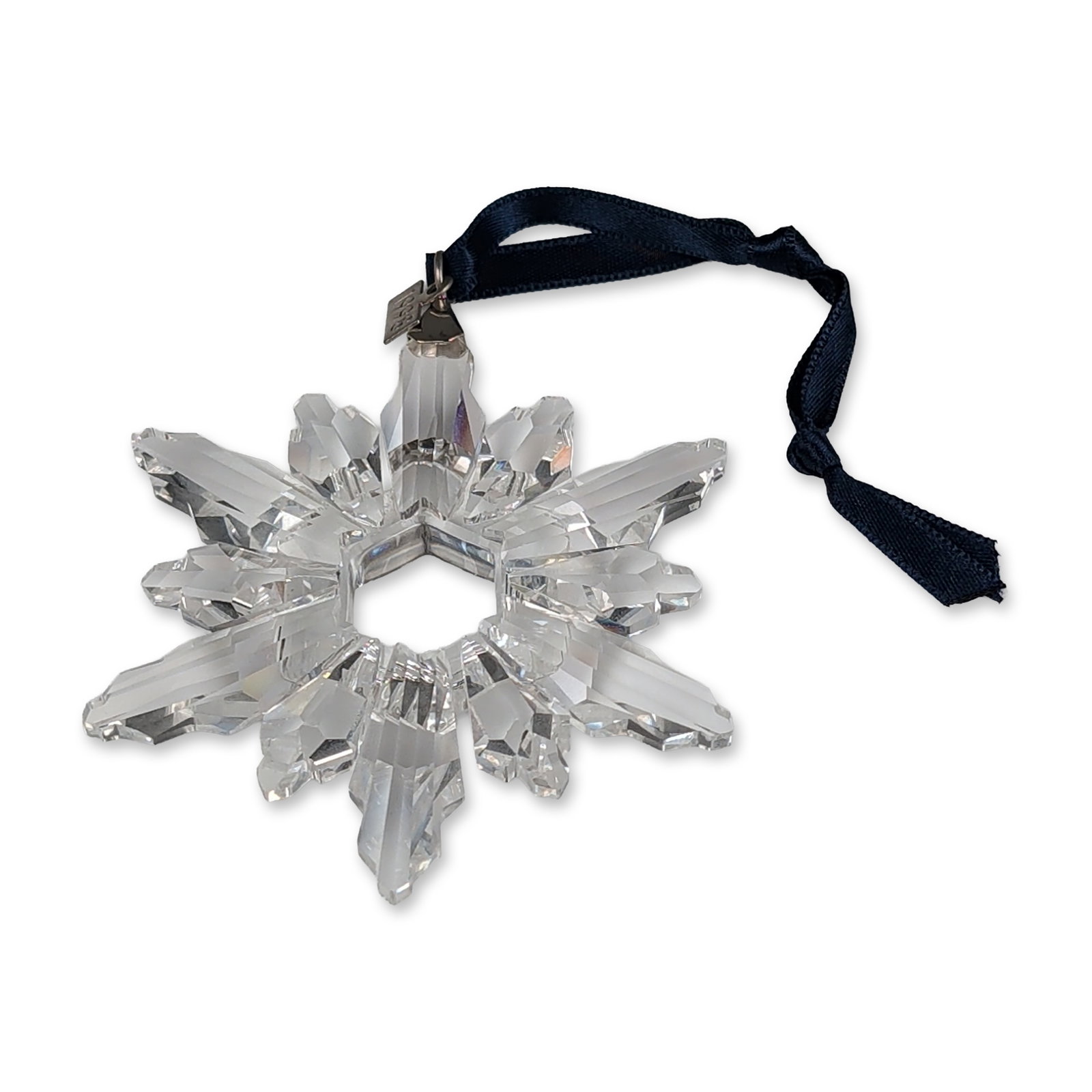Swarovski 1998 Crystal Annual Edition Ornament: Swarovski Annual Edition 1998 Christmas ornament in faceted lead crystal, designed as a multi-pointed star with a central hexagonal aperture. The piece includes a silver-tone metal clip and hang tag s