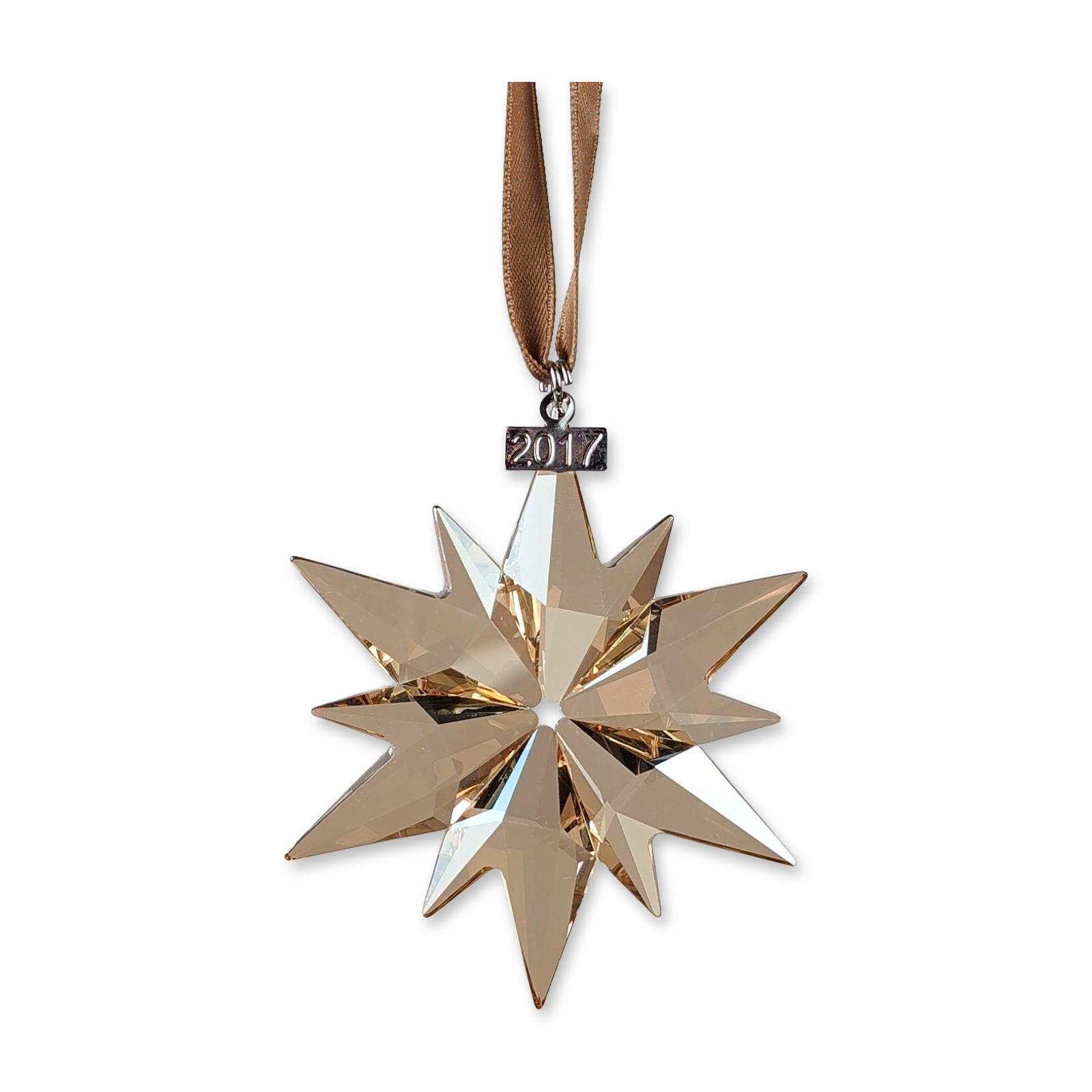 Swarovski SCS 2017 Annual Edition Star Ornament: Swarovski SCS Christmas Ornament, Annual Edition 2017. Faceted lead crystal ornament in the Golden Shadow colorway, designed as a multi-pointed star. The piece is suspended from a coordinated brown sa