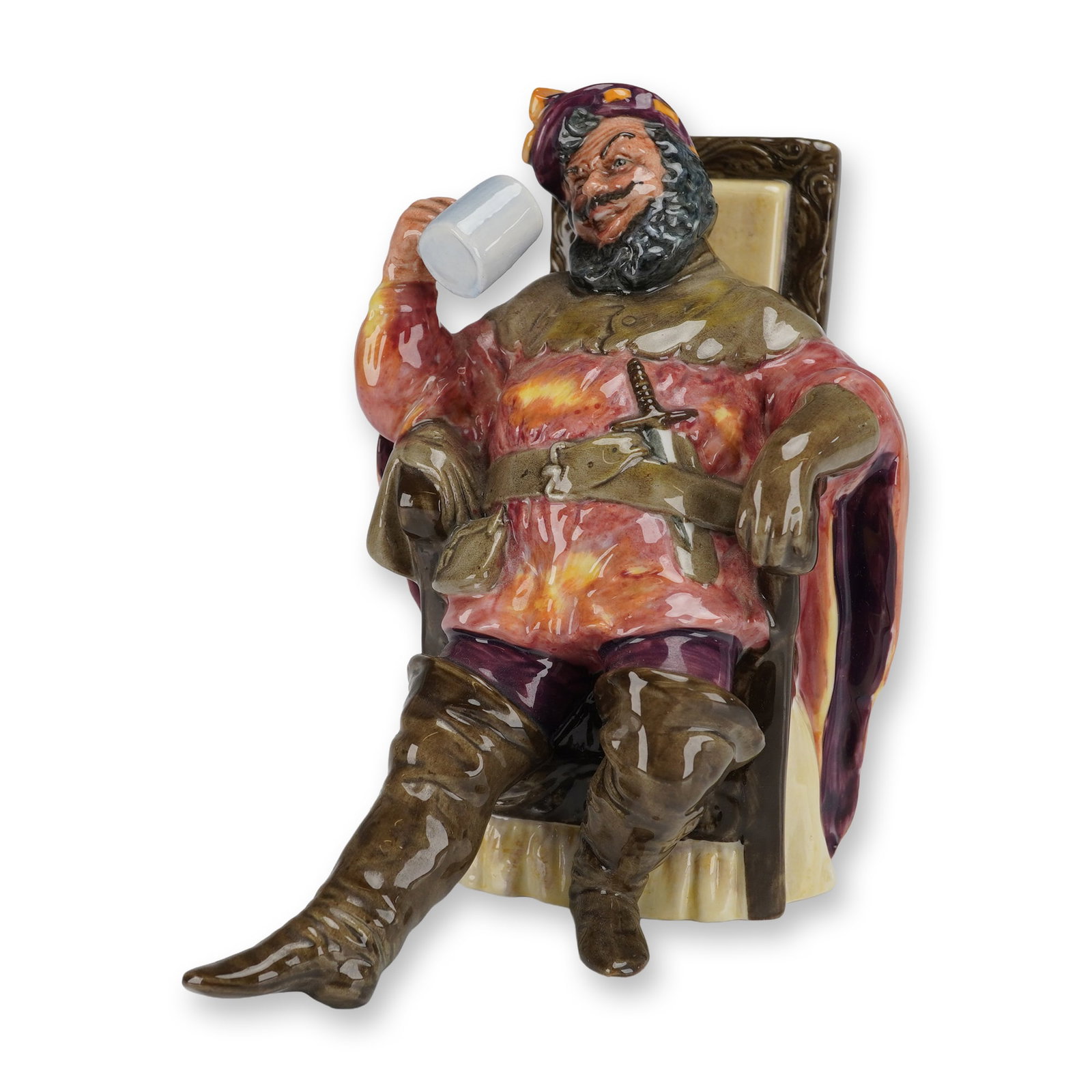 Royal Doulton Figurine The Foaming Quart HN2162: The figure depicts a seated man in colorful period costume, holding a white drinking mug to his mouth. The figure is modeled in highly saturated, high-gloss polychrome glazes, featuring deep browns, r