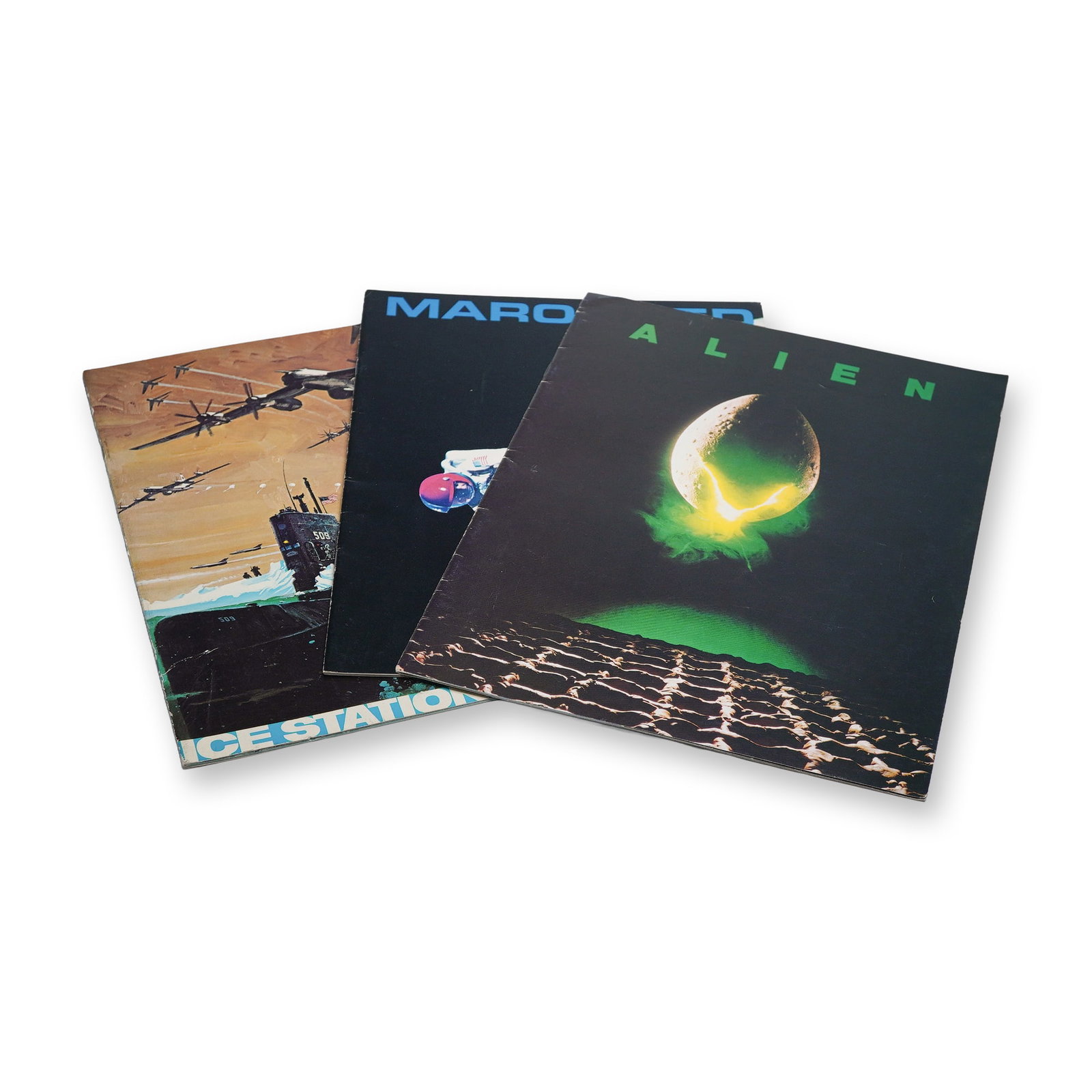 3pc ALIEN and other Movie Promotional Material: Lot of 3 vintage movie promotional booklets featuring titles from science fiction and action cinema. Includes Alien with its iconic egg cover, Marooned featuring a dramatic spacewalk scene, and Ice St