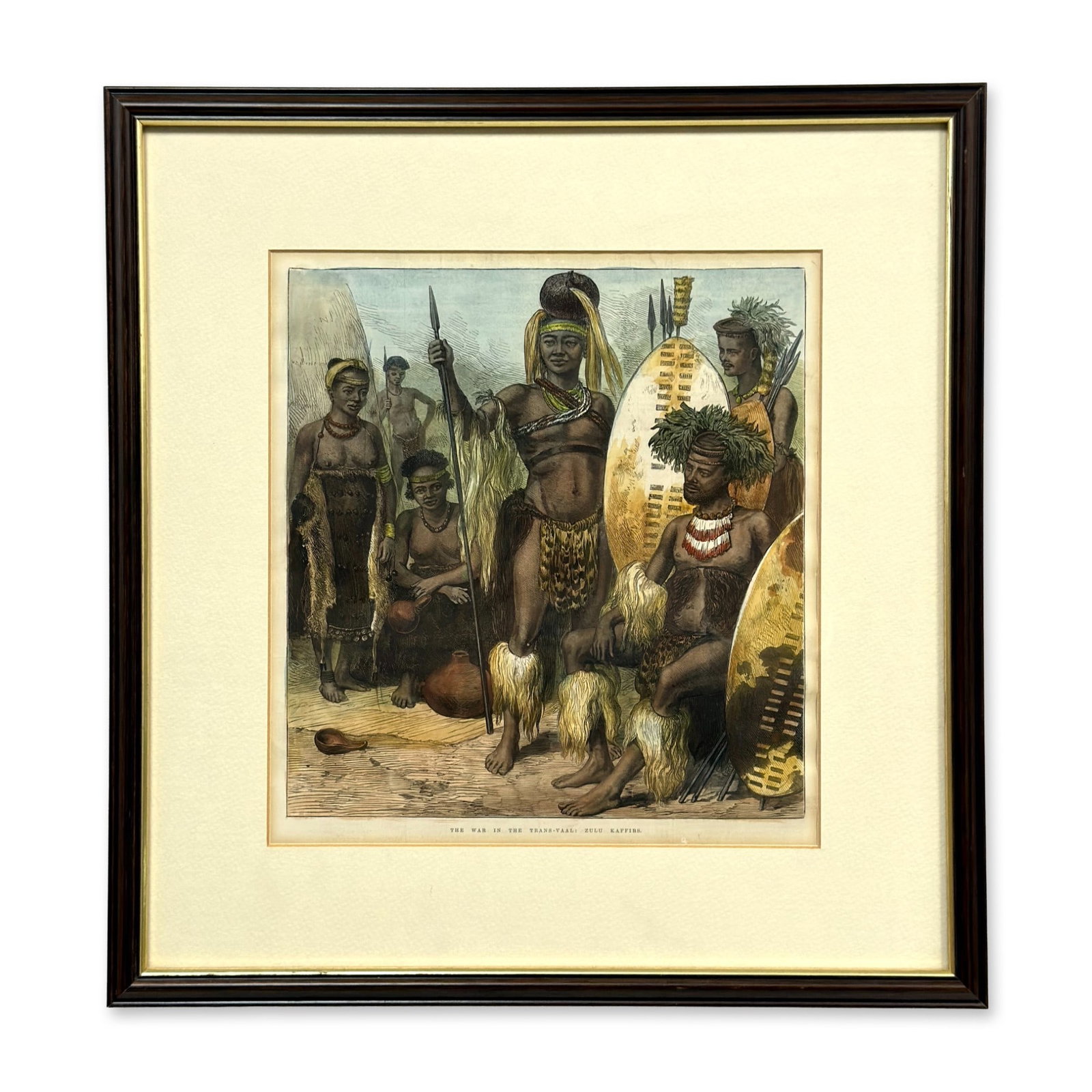 Hand-Colored Engraving, The War in the Trans-Vaal: Zulu Kaffirs: This item is a hand-colored engraving on paper, depicting a group of Zulu individuals in traditional attire. The central figures include men holding large hide shields and spears, while the women are