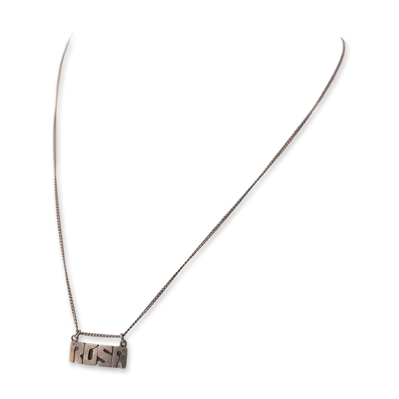 Sterling Silver Personalized Rosa Nameplate Necklace: Sterling silver necklace featuring an integrated nameplate pendant with stylized cutout block letters spelling Rosa. The pendant is attached to a fine curb link chain secured by a spring-ring clasp.