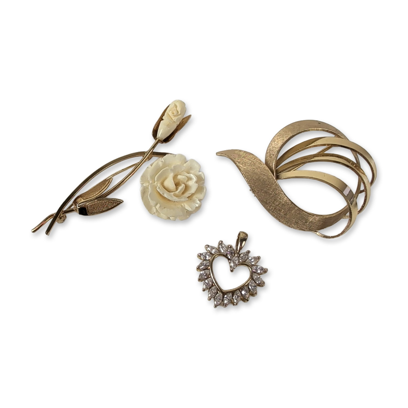 Three Vintage Gold Filled and Costume Jewelry: West German modernist and floral style. Trio of vintage jewelry pieces comprising two brooches and one pendant. The first brooch features a modernist abstract swirling ribbon design in 14 karat gold-f