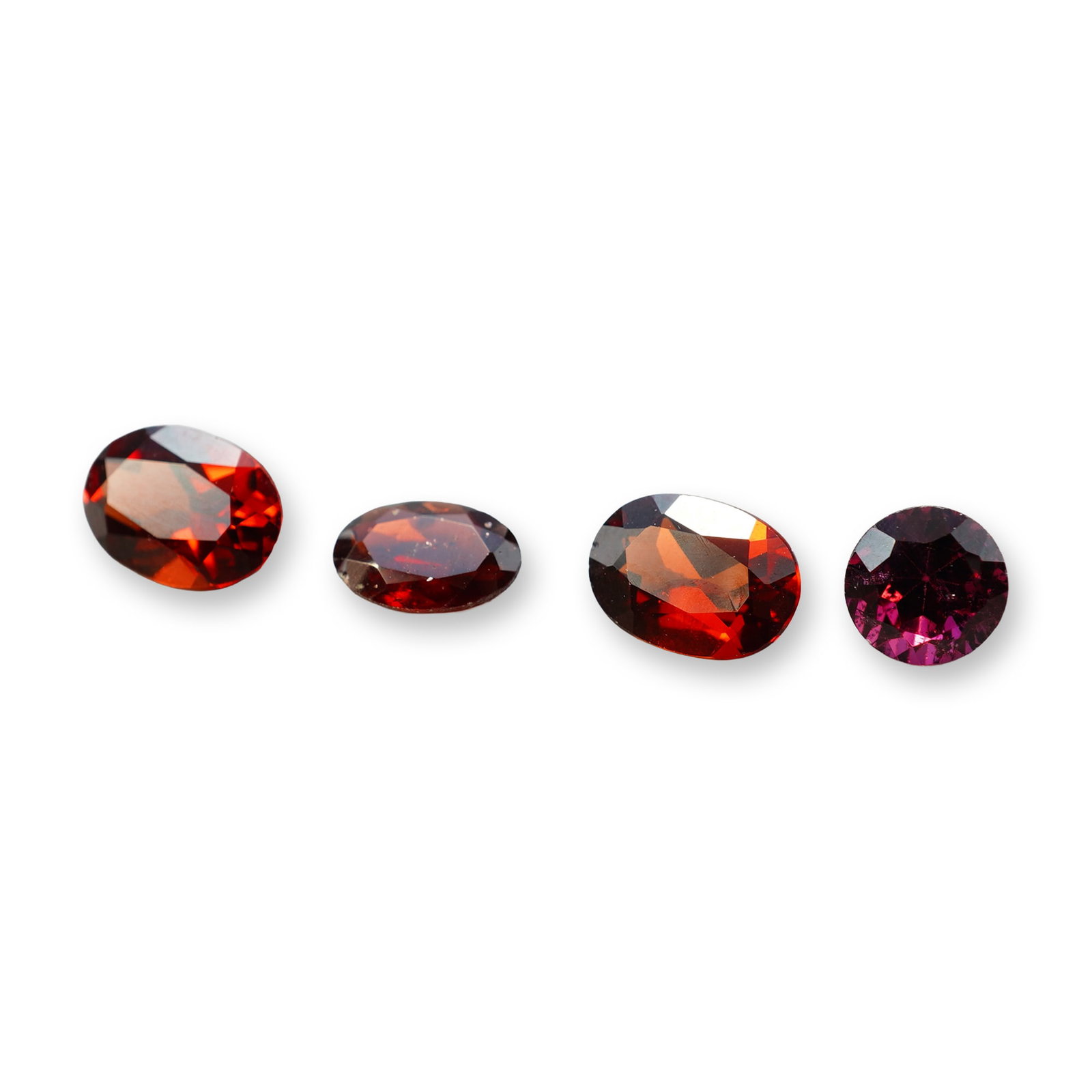 4pc Red Garnet Gemstones in Vatious Shapes and Sizes: Grouping of 4 garnet gemstones. The spiritual meaning of a garnet centers on vitality, protection, and devotion. Known as a stone of passion and commitment, it is highly valued for grounding