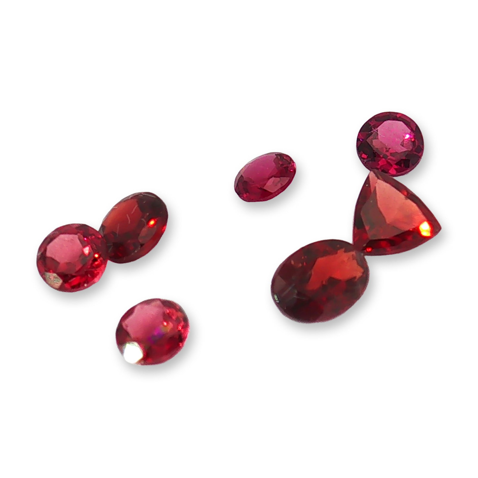 7pc Red Garnet Gemstones in Vatious Shapes and Sizes: Grouping of 7 garnet gemstones. The spiritual meaning of a garnet centers on vitality, protection, and devotion. Known as a stone of passion and commitment, it is highly valued for grounding
