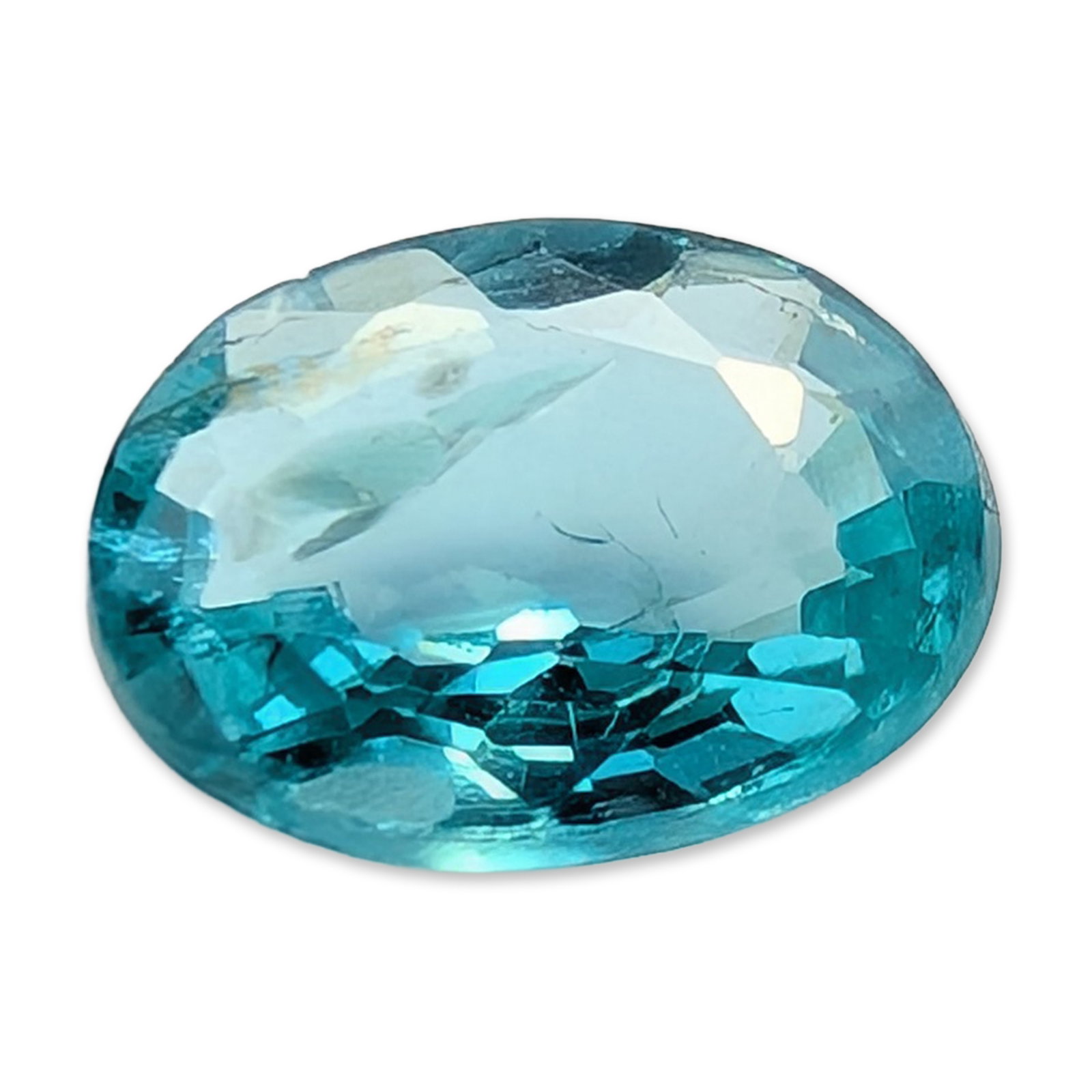Oval Cut Neon Blue Green Faceted Apatite Gemstone: Faceted gemstone appears to be neon blue-green apatite in an oval mixed cut. The stone displays a highly saturated neon or electric blue-green hue. Visual inspection reveals significant eye-visible in