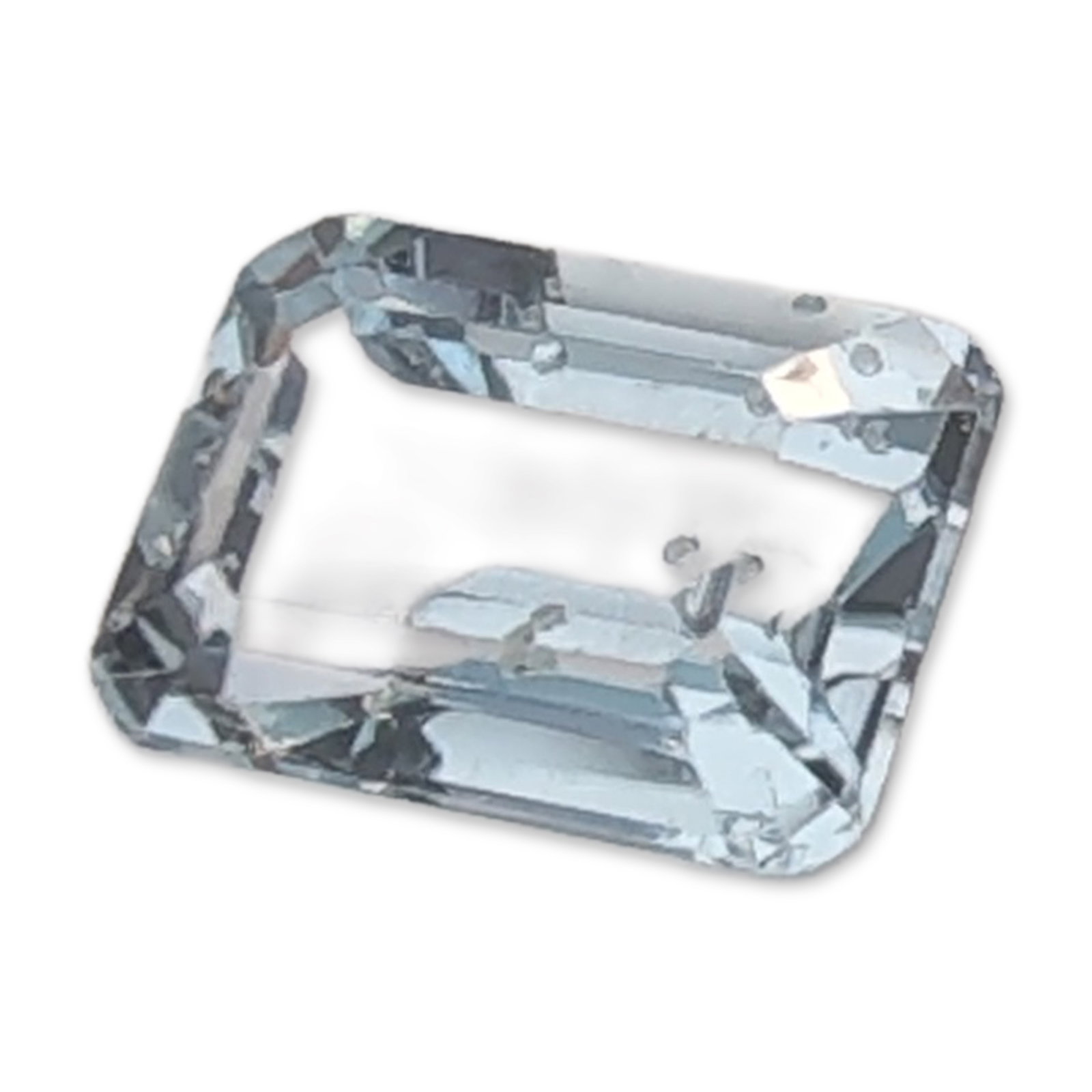 Emerald Cut Topaz Gemstone: Loose Topaz gemstone featuring a rectangular emerald cut with truncated corners. The stone exhibits a transparent, very pale blue color with visible internal needle-like inclusions, often referred to 