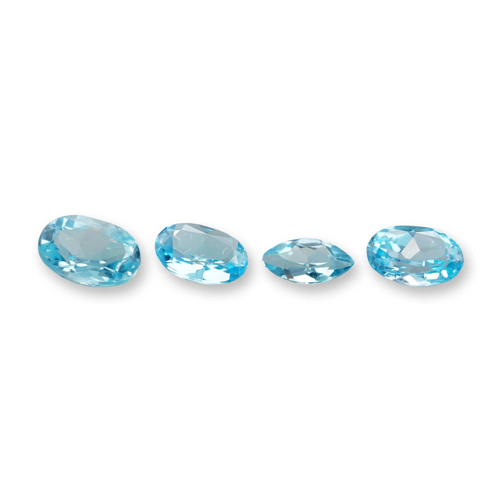 4pc Oval and Marquise Cut Blue Topaz Gemstones: Grouping of 4 Blue Topaz stones. Blue topaz is a striking, durable semi-precious gemstone known for its glassy luster and excellent clarity. Blue topaz meaning, in particular, is associated with