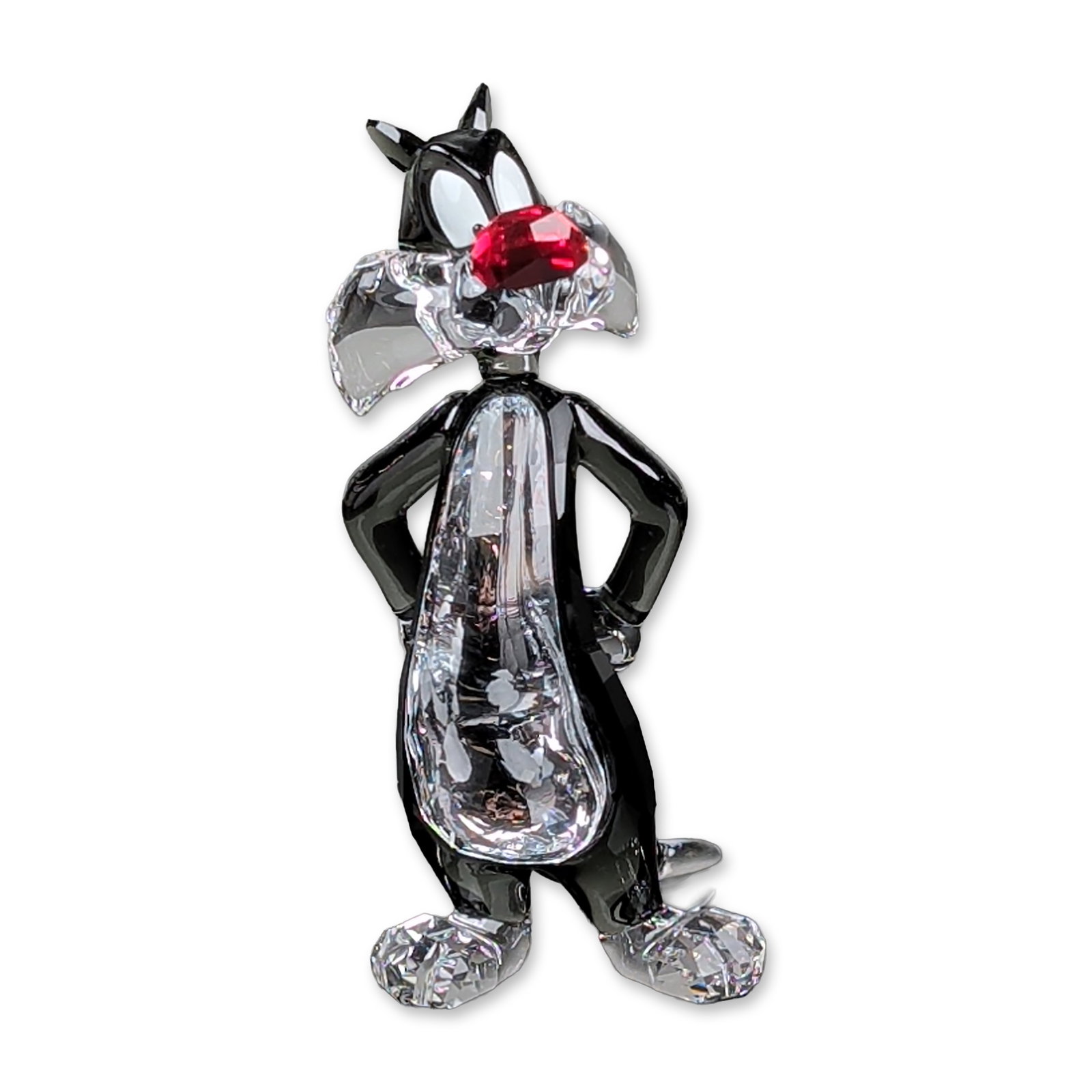 Swarovski Crystal Looney Tunes Sylvester Figurine: Swarovski faceted lead crystal figurine depicting the character Sylvester the Cat from the Looney Tunes animated series. The figure is modeled in a characteristic leaning pose with arms behind the