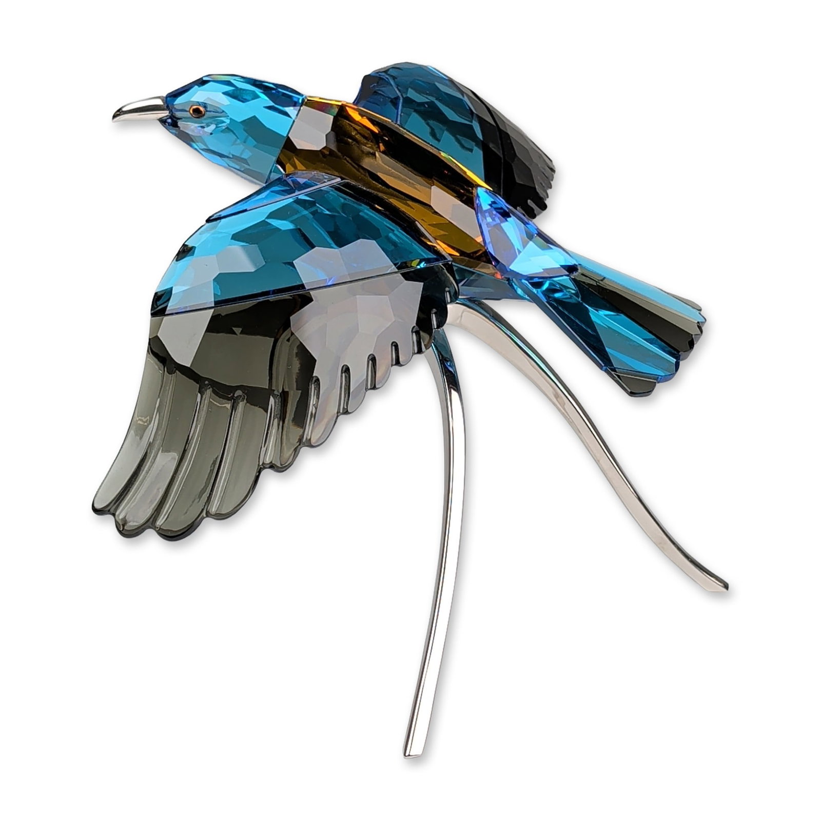 Swarovski Crystal Paradise Birds Figurine, Roller Bird: Roller bird figurine, part of the Silver Lake collection, is in faceted blue, dark gray, and brownish-amber crystal, depicting a bird in flight. The piece is mounted on a three-pronged chrome-finished