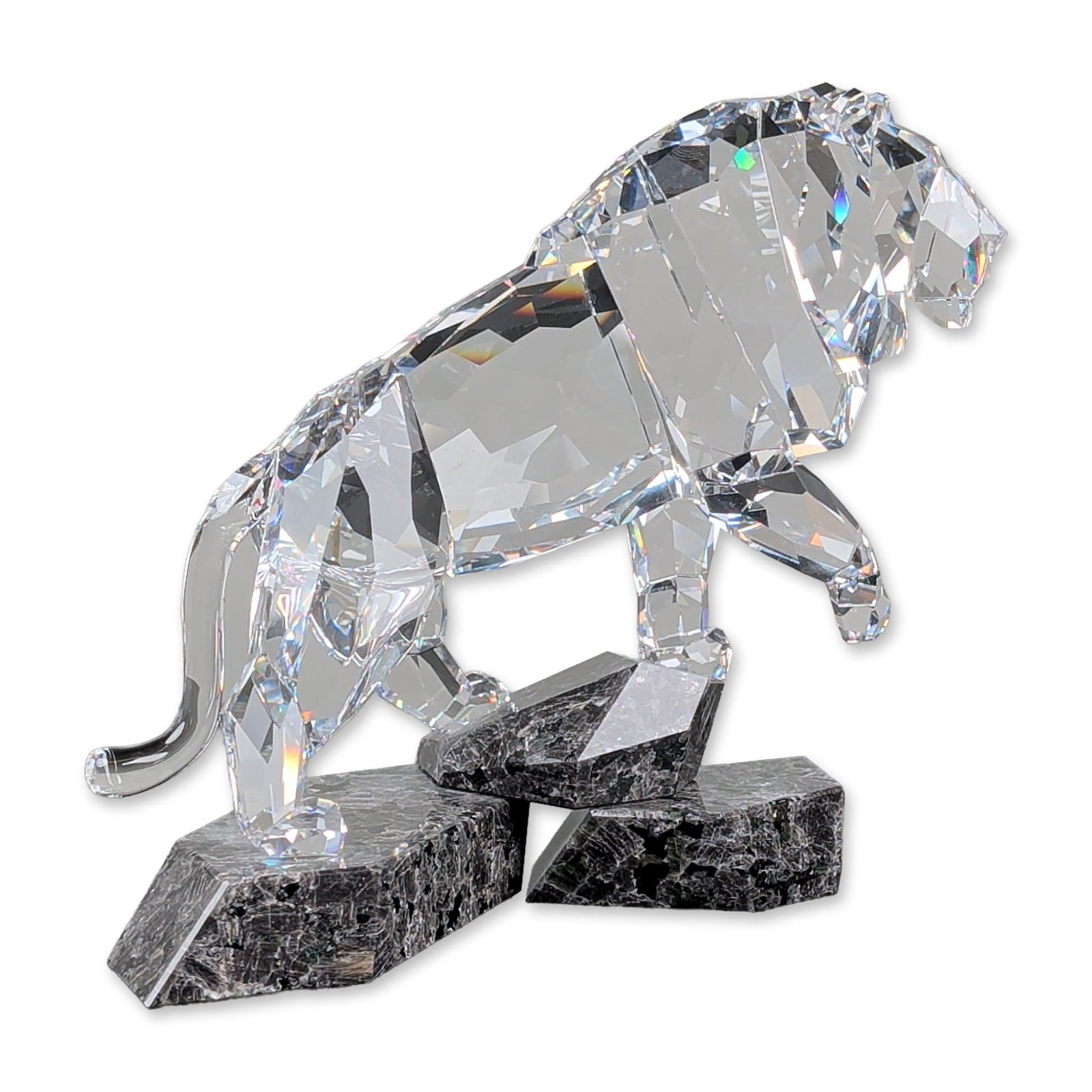 Swarovski Crystal Soulmates Spirit of Nobility Lion Sculpture: Swarovski crystal sculpture from the Spirit of Nobility collection, titled The Brave and Proud Lion. The piece features a faceted clear lead crystal lion in a pouncing posture, mounted to a naturalist