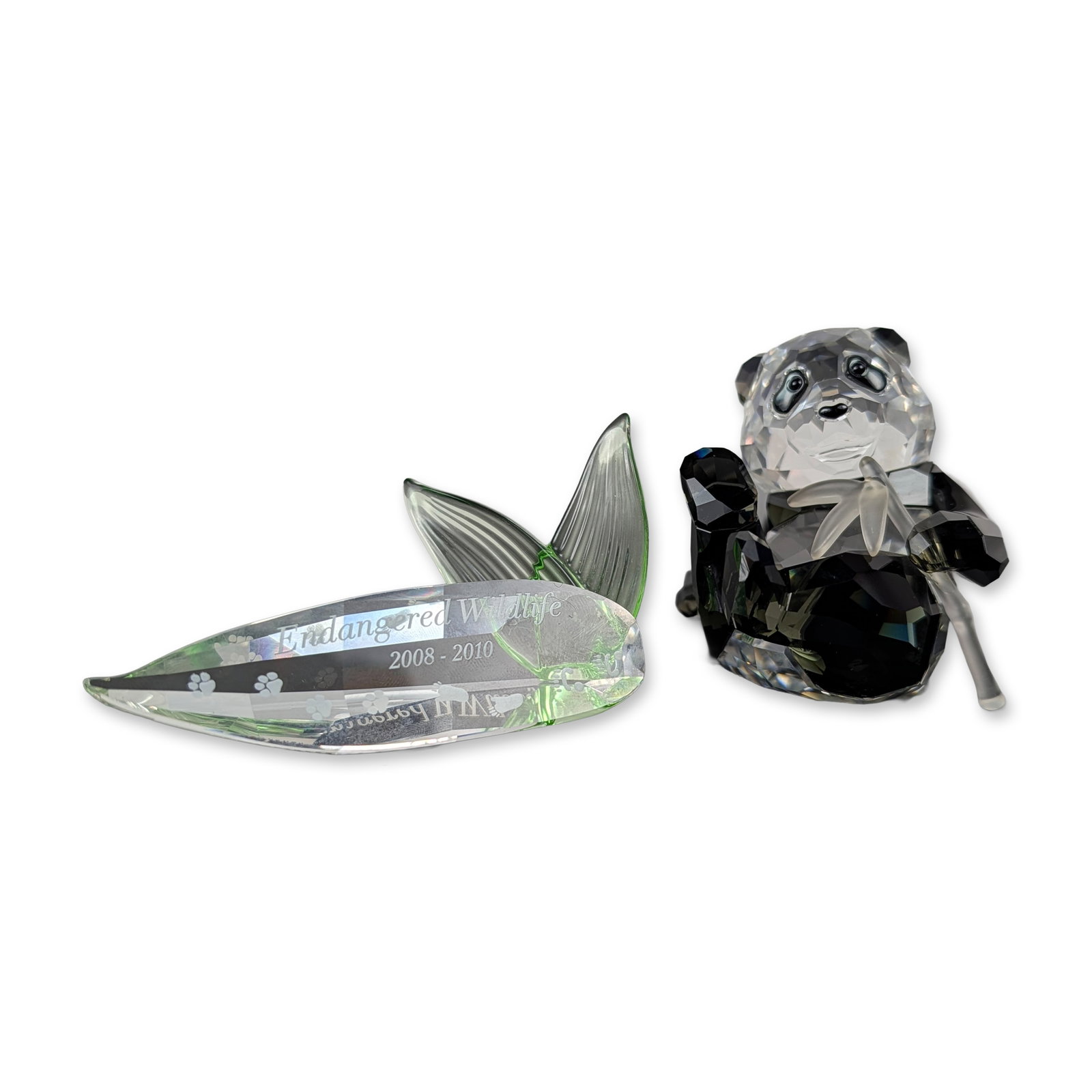 2pc Swarovski SCS 2008 Panda Cub and Title Plaque: Swarovski Crystal Society (SCS) 2008 Annual Edition Panda Cub figurine and matching title plaque. The panda figurine is constructed in multi-faceted clear lead crystal with black-tinted crystal used f