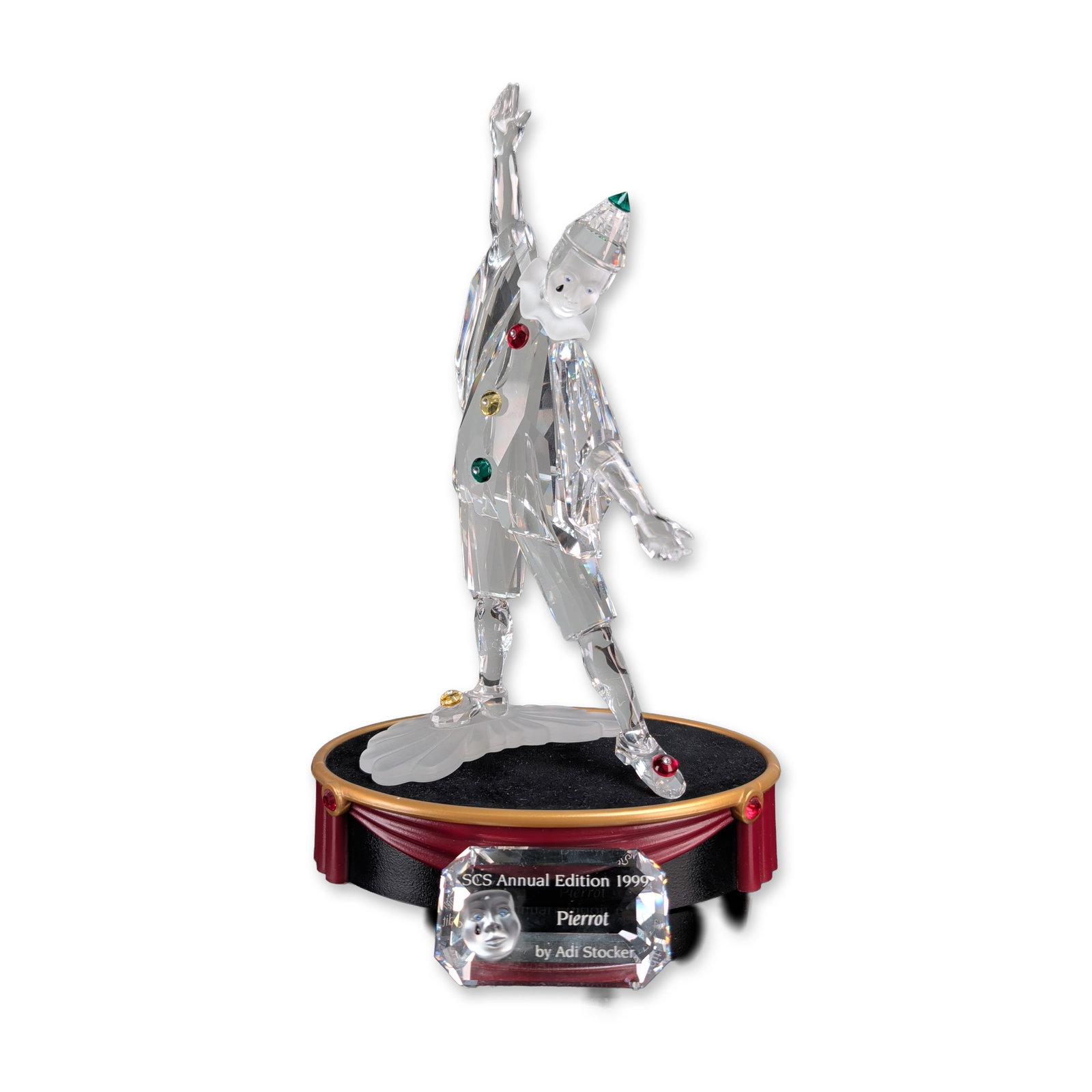 3pc Swarovski 1999 SCS Pierrot Crystal Figurine w/ Stand & Plaque: Swarovski 1999 Crystal Society (SCS) Annual Edition figurine, Pierrot, the first issue in the Masquerade trilogy. The faceted clear lead crystal figure features a frosted crystal face and a frosted ba