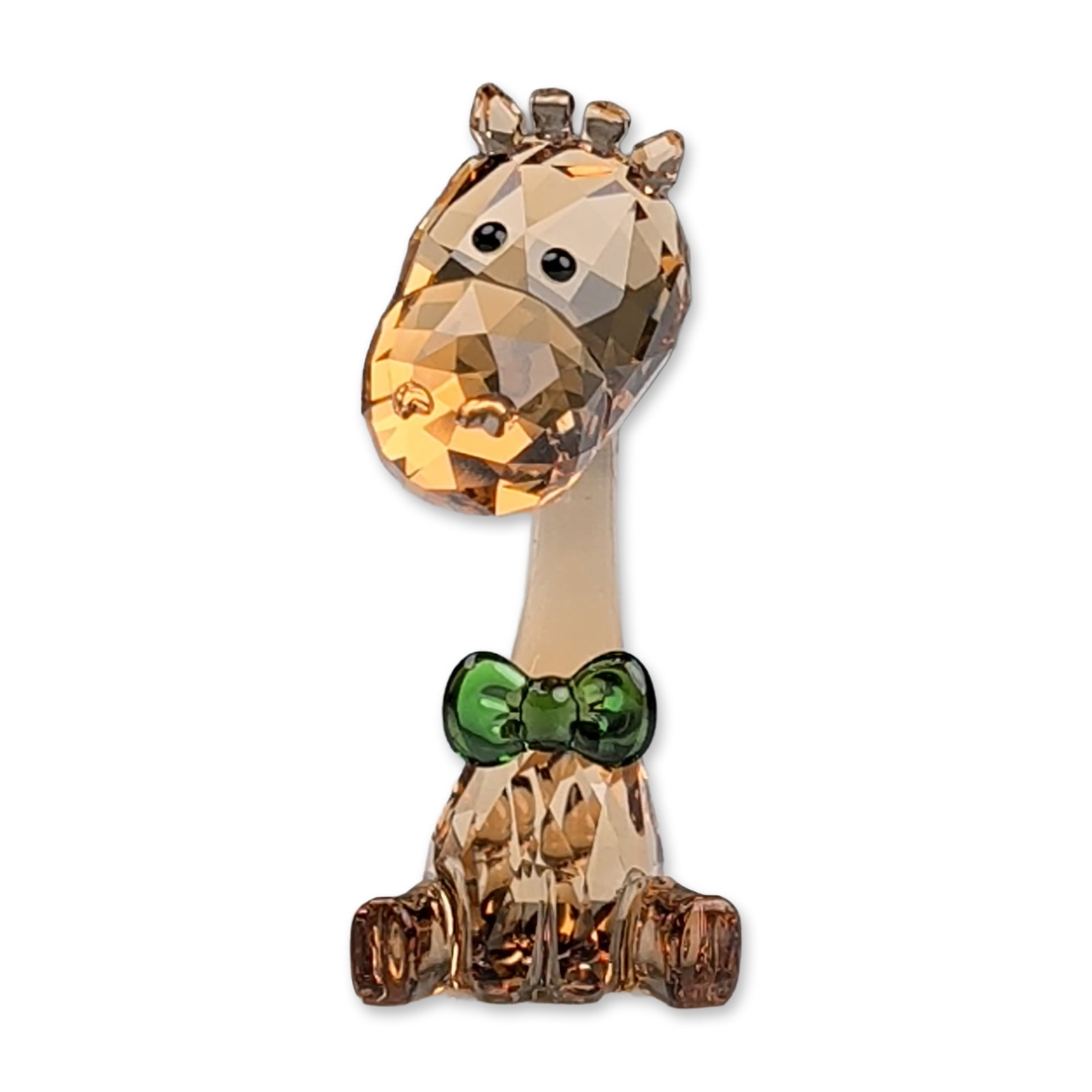 Swarovski 2018 SCS Loyalty Gift Giraffe Figurine: Swarovski Crystal Society 2018 loyalty gift figurine depicting a seated baby giraffe. The figure is constructed of faceted light amber crystal with dark amber crystal accents at the hooves and ossicon