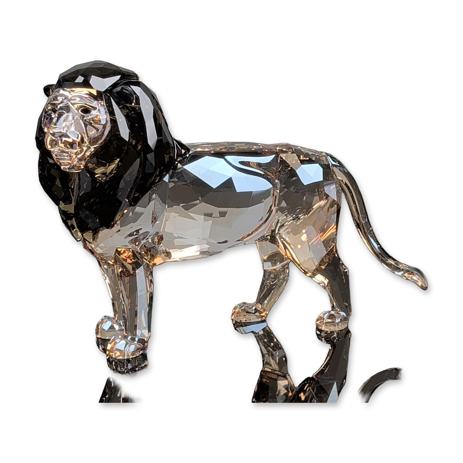 Swarovski Crystal SCS 2016 Annual Edition Figurine, Akili Lion: Lion Akili figurine in faceted lead crystal, featuring a dark smoke-colored mane and Golden Shadow amber-toned body with dark crystal eyes. Etched Swarovski swan hallmark located on the underside of a