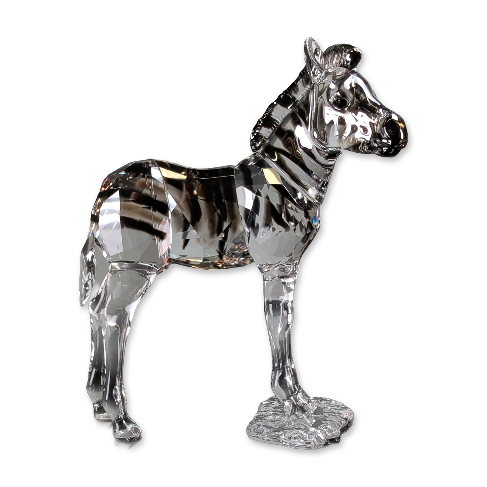Swarovski SCS Elegance of Africa Zebra Amai Figurine: Swarovski crystal figurine titled Amai from the Elegance of Africa SCS Annual Edition collection. The piece is constructed from clear faceted crystal with dark-toned crystal stripes. The zebra is depi