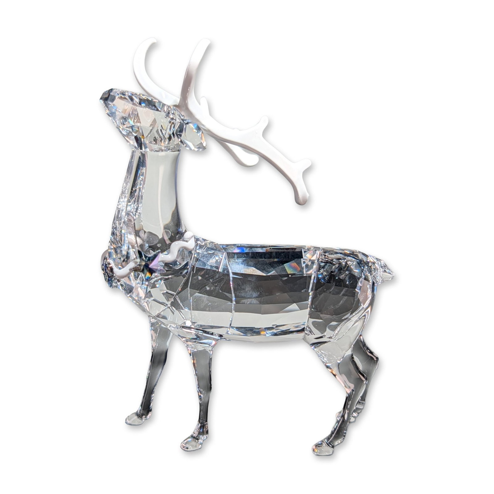 Swarovski Crystal Christmas Stag Figurine: Swarovski crystal Christmas Stag figurine in clear faceted crystal, featuring matte white finished antlers and a decorative neck collar. The piece is marked with an etched Swarovski swan logo on the u