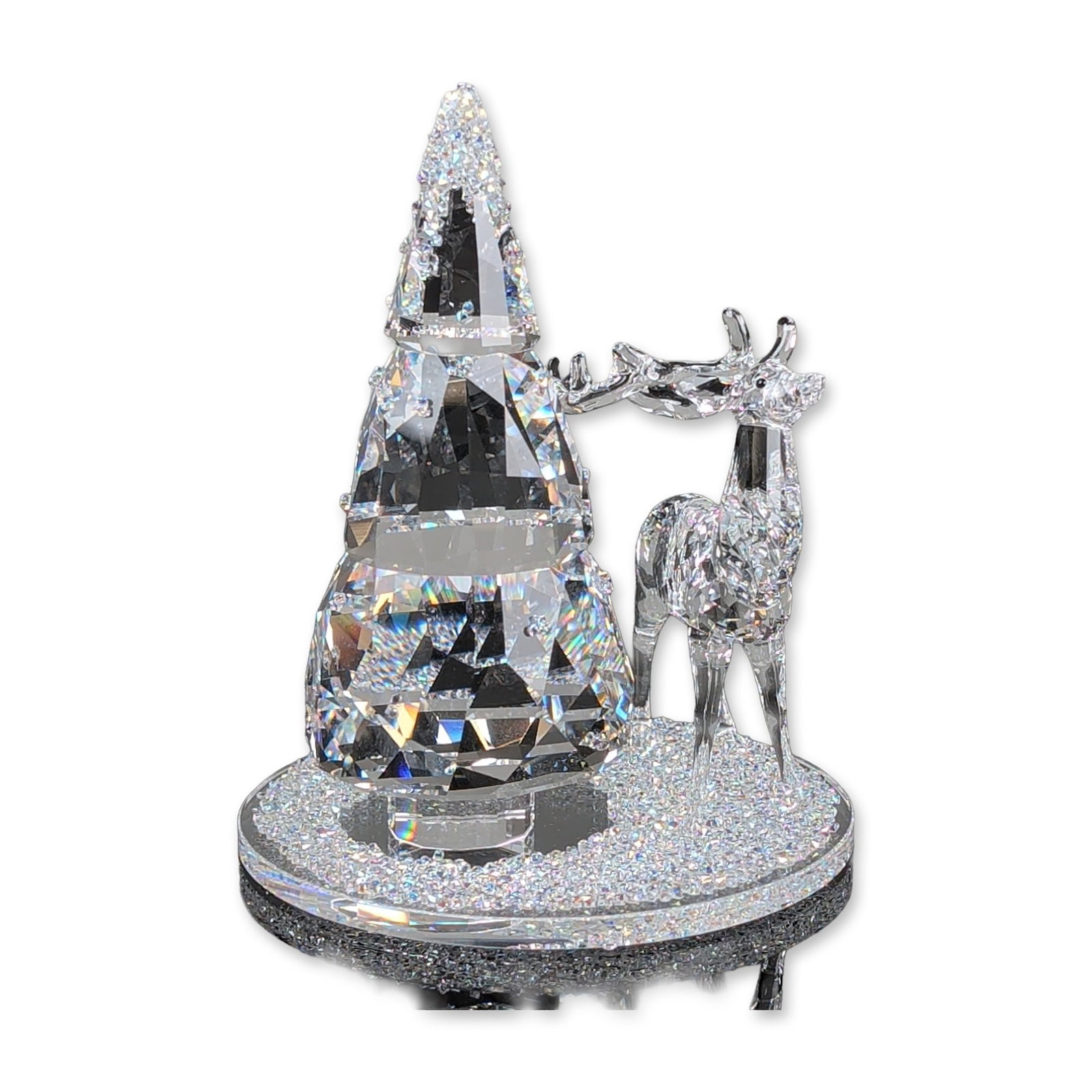 Swarovski Crystal Holiday Bell Jar, Pine Tree and Stag: Swarovski crystal figurine set from the Festive collection, featuring a faceted reindeer and a multi-faceted pine tree. The figures are mounted to a circular base encrusted with clear crystal chatons.