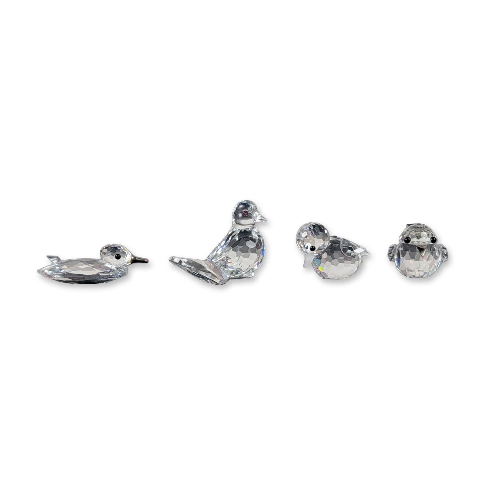 4pc Swarovski Silver Crystal Bird Figurine Collection: This crystal grouping features four avian specimens curated from the Swarovski Silver Crystal line. The assembled set features an articulated selection of wildlife, including a mini duck with a metal