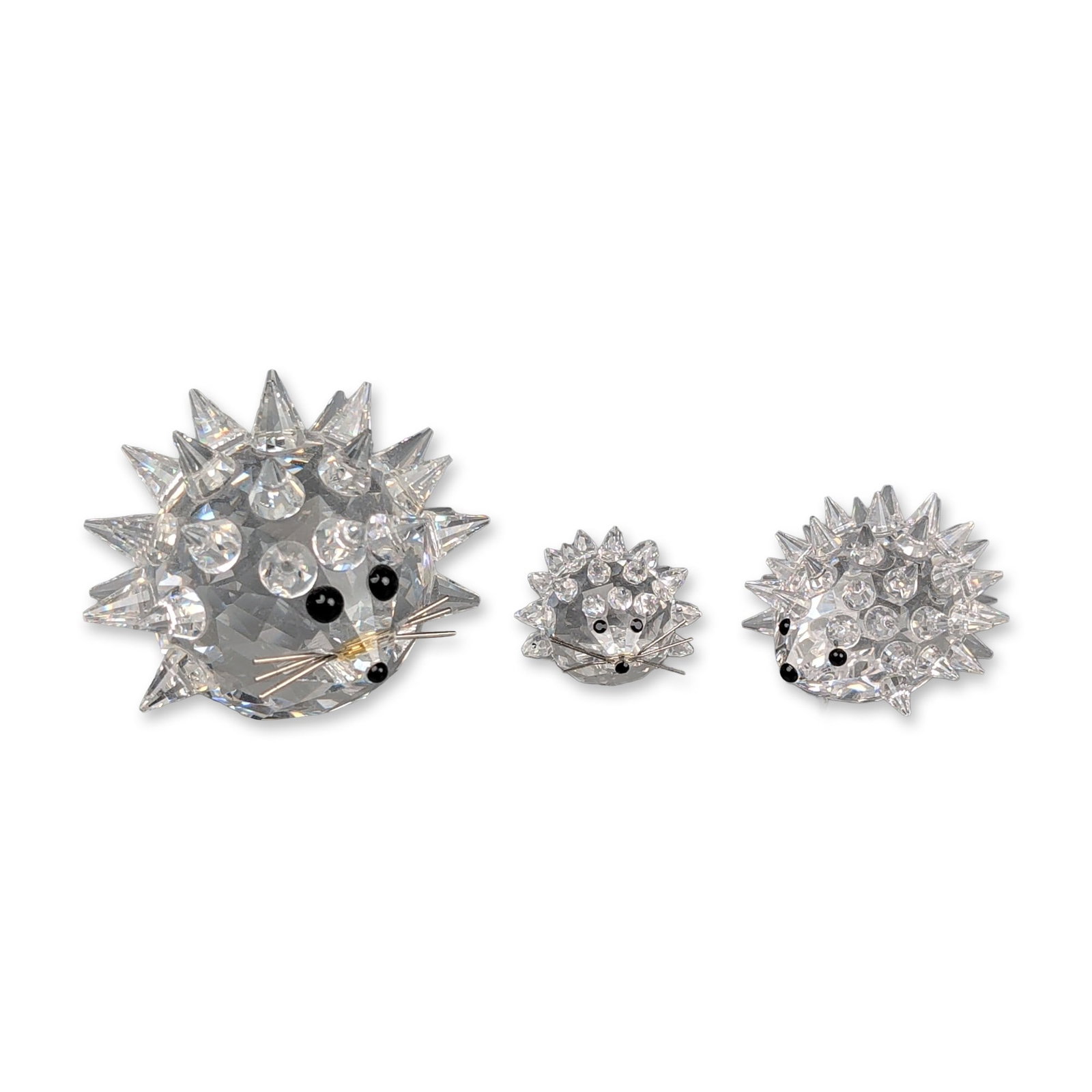 Three Swarovski Silver Crystal Figurines, Graduated Hedgehogs: Crystal graduated hedgehog figurines, including three examples in large, medium, and small sizes. Each figure is constructed from faceted clear lead crystal with numerous pointed spikes, black bead ey
