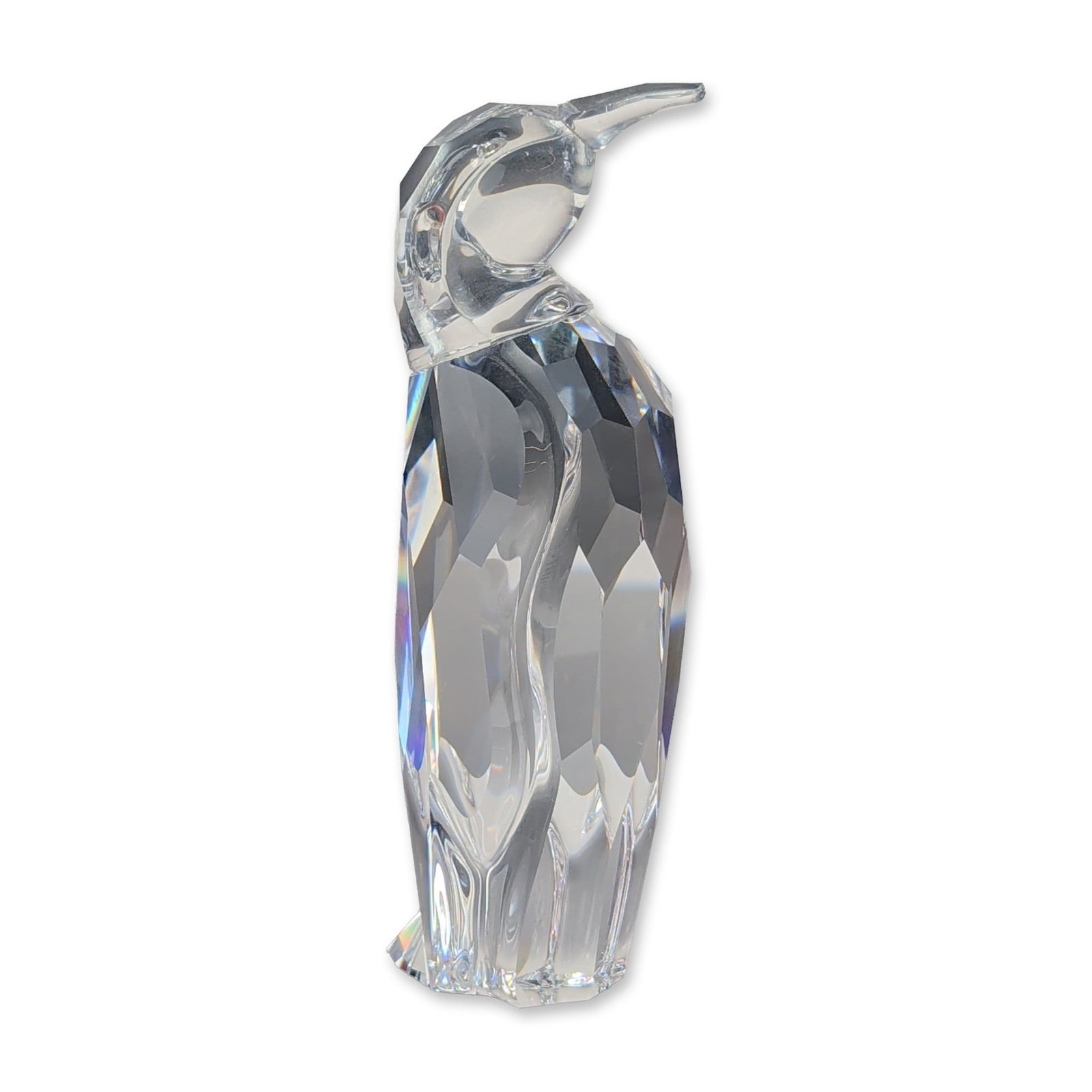 Swarovski Faceted Lead Crystal Penguin Father Figurine: Swarovski faceted lead crystal figurine depicting a penguin father. The piece features a multi-faceted body with a smooth, polished head, crest, and long, pointed beak. The underside of the figurine b