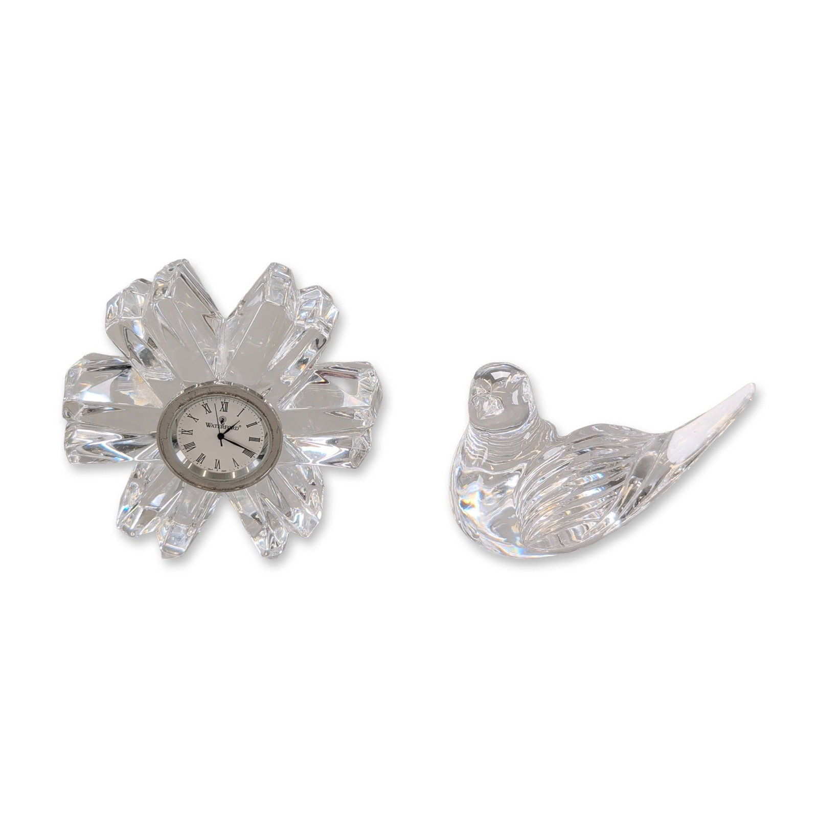 2pc Waterford Lead Crystal Bird Paperweight and Flower Clock: Waterford crystal group including a stylized bird figurine and a flower-form desk clock. The bird figurine features horizontal ribbing on a rounded body with a pointed tail and an acid-etched mark on 
