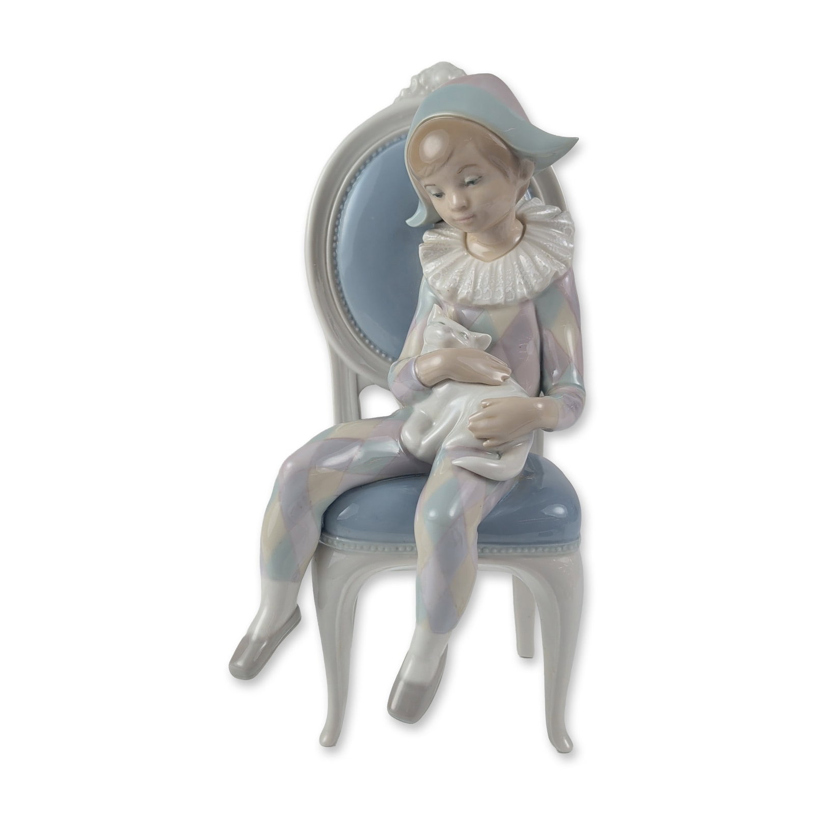 Lladro Porcelain Figurine, Young Harlequin 1001229: The piece features a young boy in a traditional harlequin suit with a multi-colored diamond pattern and a white ruffled collar, seated on a light blue and white chair while cradling a white cat. The u