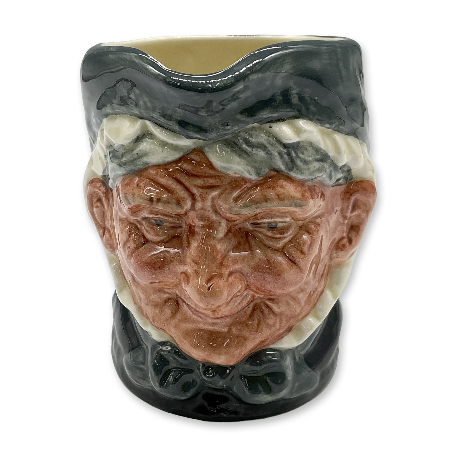 Granny D6384 - Small - Royal Doulton Character Jug: Style One, Toothless Granny. Dark green and white coloration. Royal Doulton backstamp. Artist: Harry Fenton Dimensions: 3.25"H Date or Era: 1935 Manufacturer or Brand: Royal Doulton Country of Ori