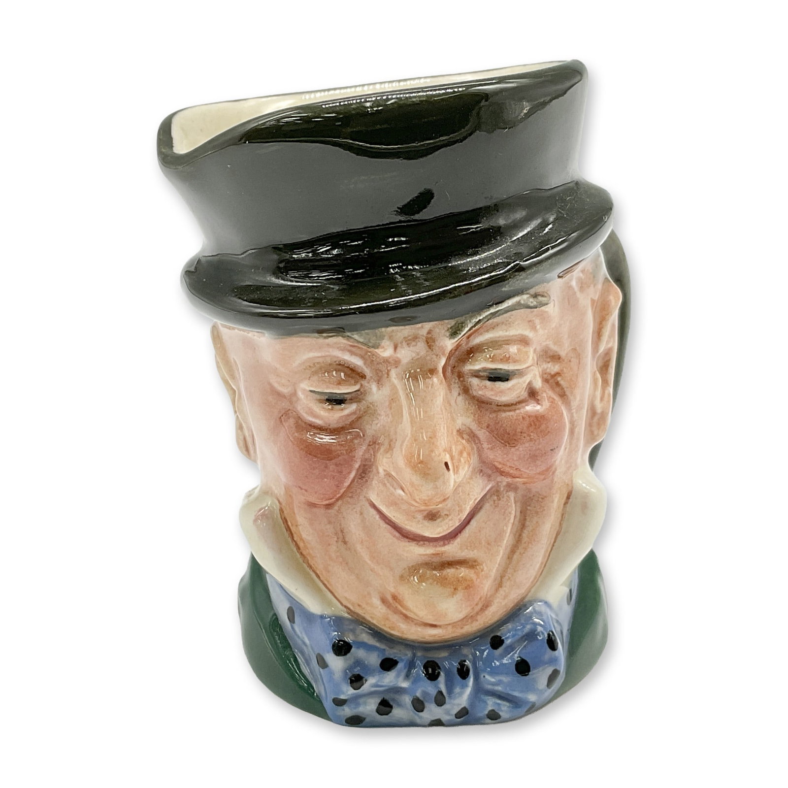 Mr. Micawber D6138 - Mini - Royal Doulton Character Jug: Style One, plain handle. Black hat; green coat; blue polka-dot bow tie. Royal Doulton backstamp. Artist: Leslie Harradine and Harry Fenton Dimensions: 2.25"H Date or Era: 1940 - 1960 Manufacturer or B