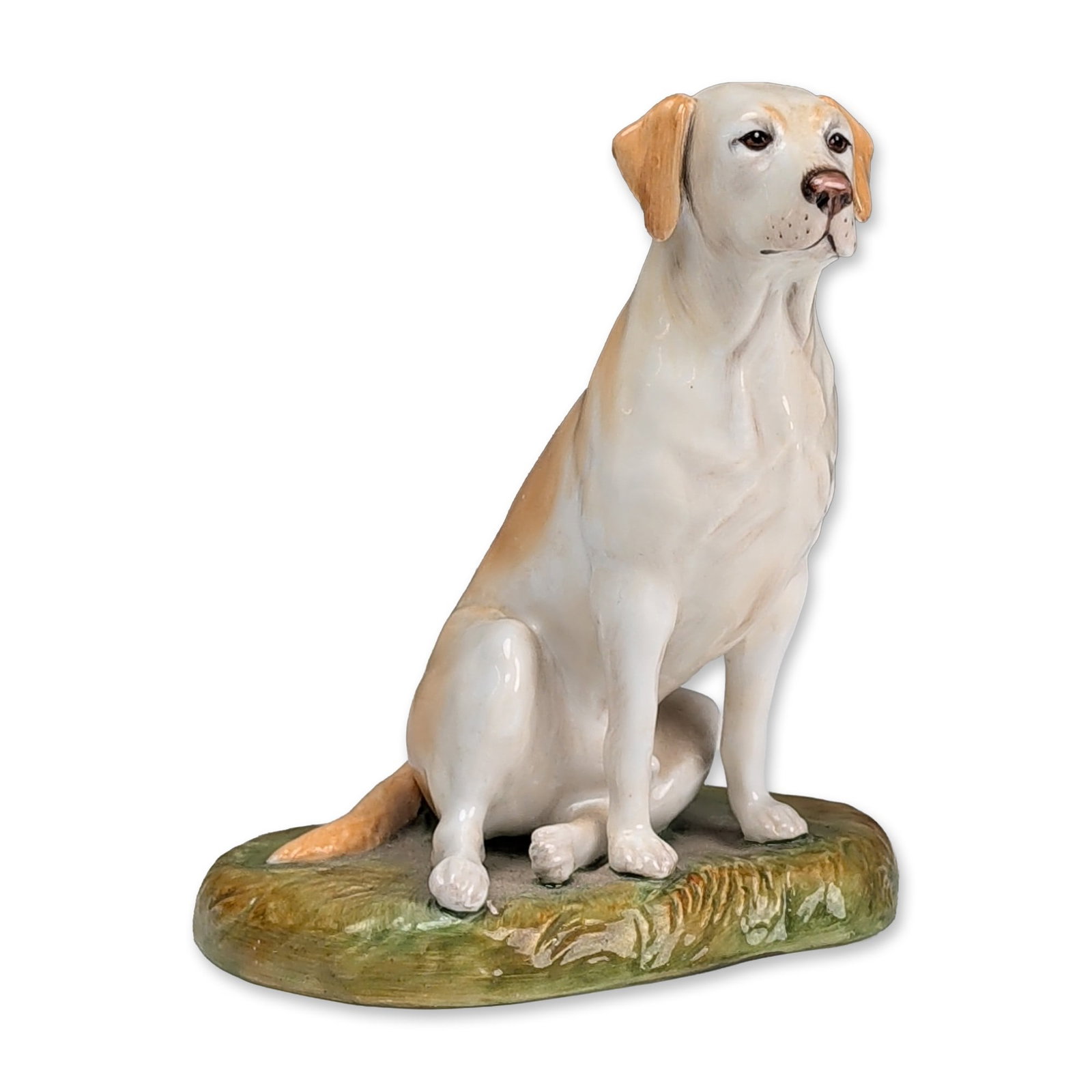 Royale Stratford Dog Figurine, Yellow Labrador Retriever: A dog figure modeled on a textured, low-profile oval base finished in green and brown tones. The dog in an attentive pose with the head looking forward. The undersides bear circular black factory mark