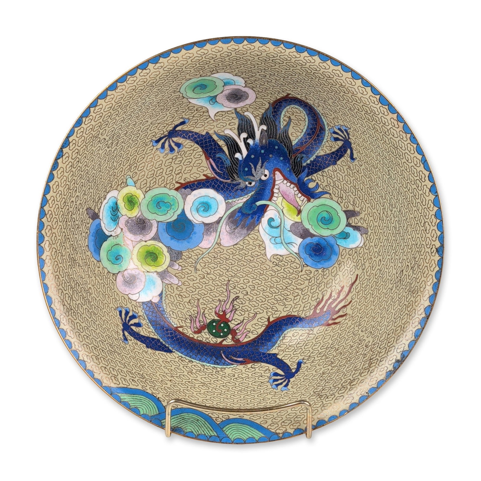 Chinese Cloisonne Enamel Dragon Bowl: 20th century Chinese export. Decorative bowl in cloisonne enamel on brass, featuring a four-clawed blue dragon amongst multi-colored ruyi clouds on both the interior and exterior. The decoration is se
