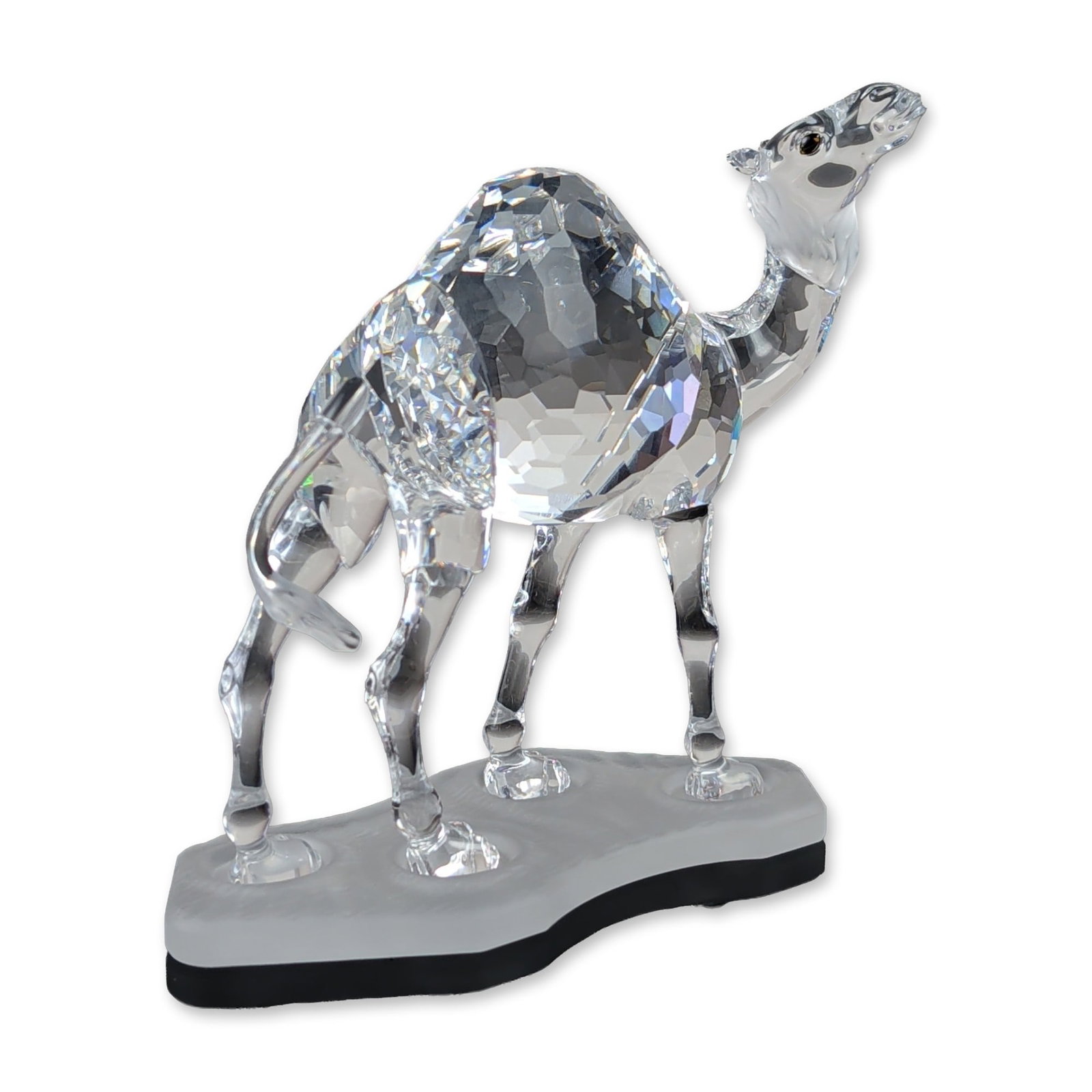 Swarovski Silver Crystal Dromedary Camel Figurine: Swarovski Silver Crystal series dromedary camel figurine, model number 247683. The figure is composed of faceted clear lead crystal with a multi-faceted hump and neck, smooth molded crystal ears and t