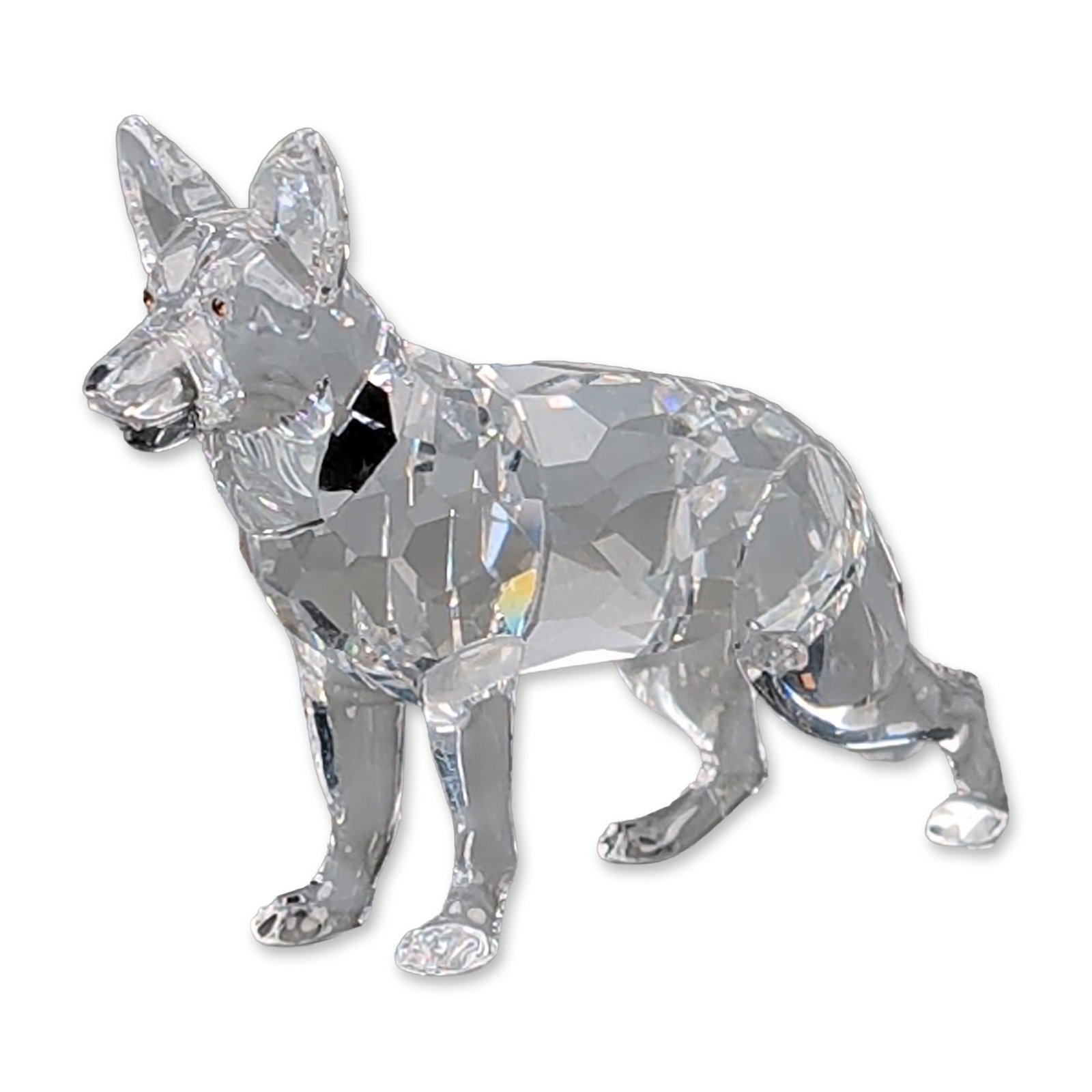 Swarovski Crystal Dog Figurine, German Shepherd: Swarovski faceted lead crystal figurine of a standing German Shepherd, featuring a precision-cut clear body with three dark crystal accents representing the eyes and nose. The piece is marked with an 