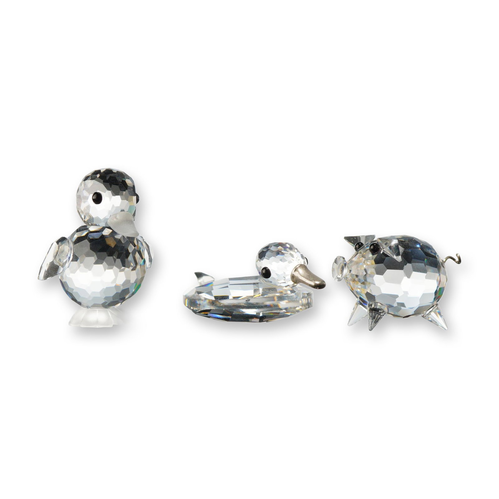 3pc Swarovski Silver Crystal Animal Figurines: Swarovski, Austria. A trio of faceted Silver Crystal animal figurines including a pig, a standing duckling, and a swimming duck. The pig features four pointed crystal feet and a curled silver-tone met