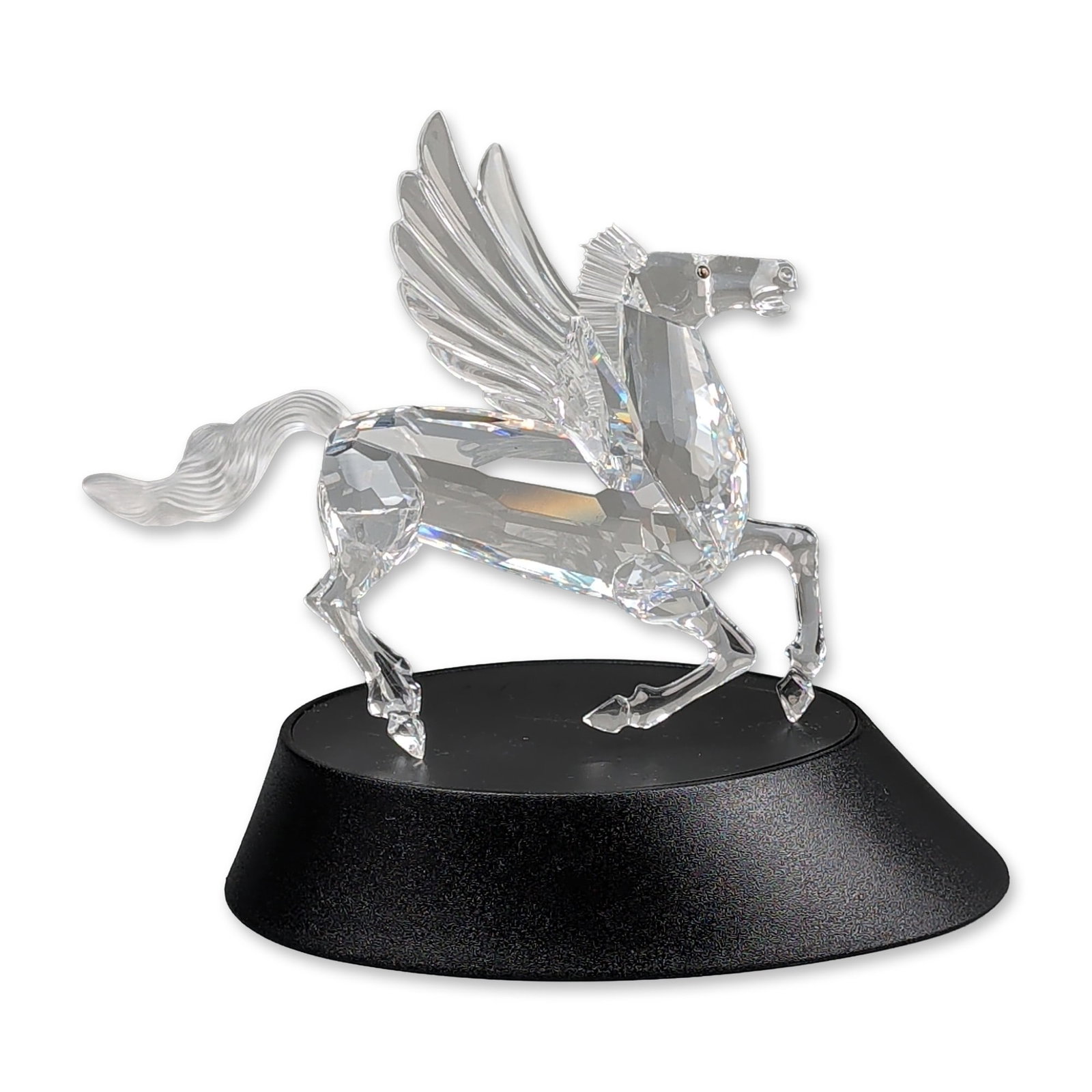 2pc Swarovski 1998 Annual Edition Crystal Figurine, Pegasus and Base: Swarovski 1998 SCS Annual Edition Pegasus figurine, the final piece of the Fabulous Creatures trilogy. The figure is constructed of faceted clear lead crystal with a frosted crystal mane and tail,