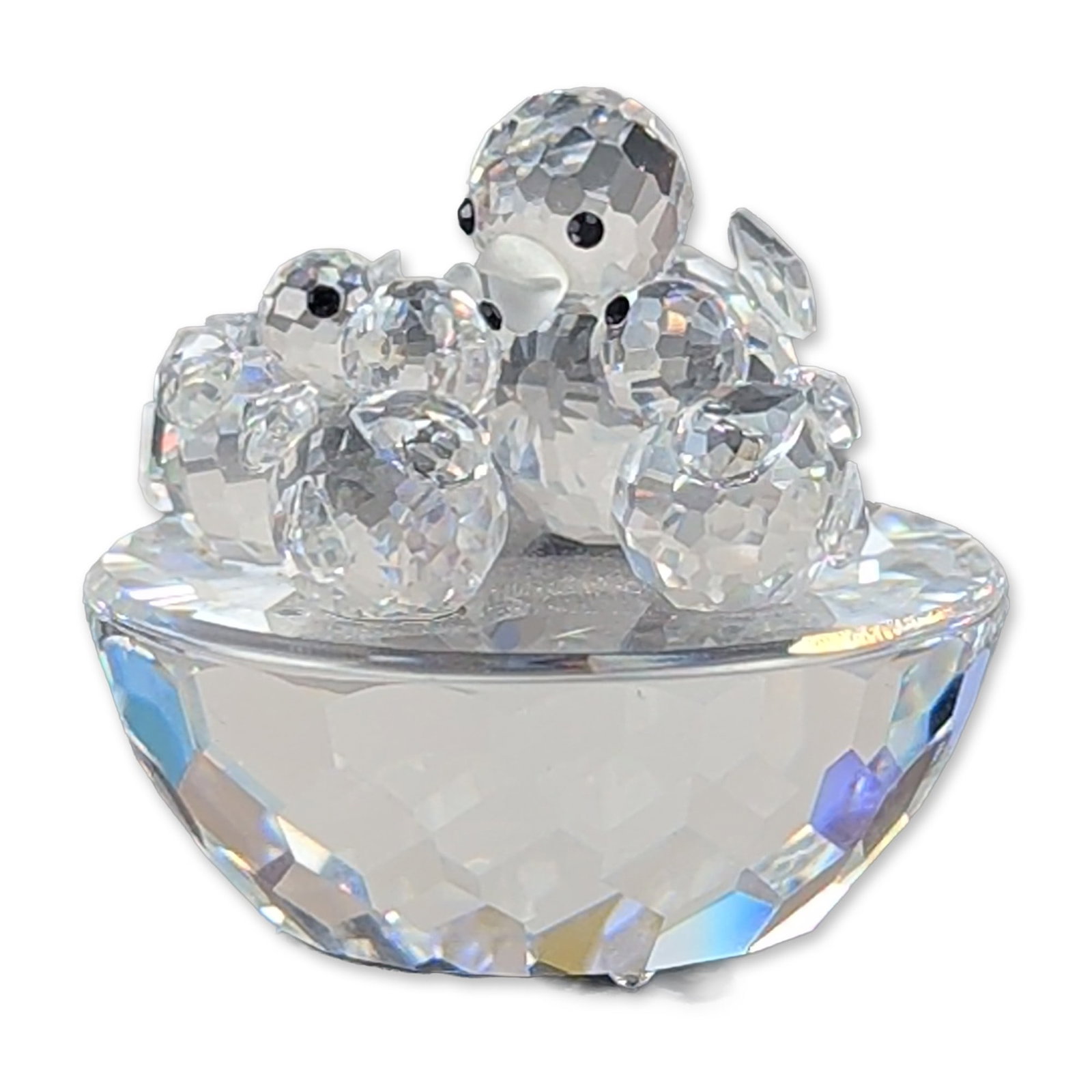 Swarovski Silver Crystal Bird's Nest Figurine: Swarovski faceted lead crystal figurine, depicting a bird's nest with three nestlings, featuring clear crystal faceted construction with small black crystal bead eyes. The underside of the base