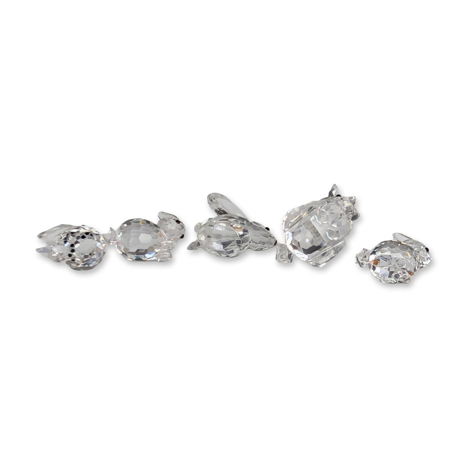 Group of Five Swarovski Silver Crystal Rabbit Figurines: Swarovski Silver Crystal group of five faceted lead crystal animal figurines including five rabbits with black bead eyes, accompanied by four original storage boxes and a commemorative coin. Model