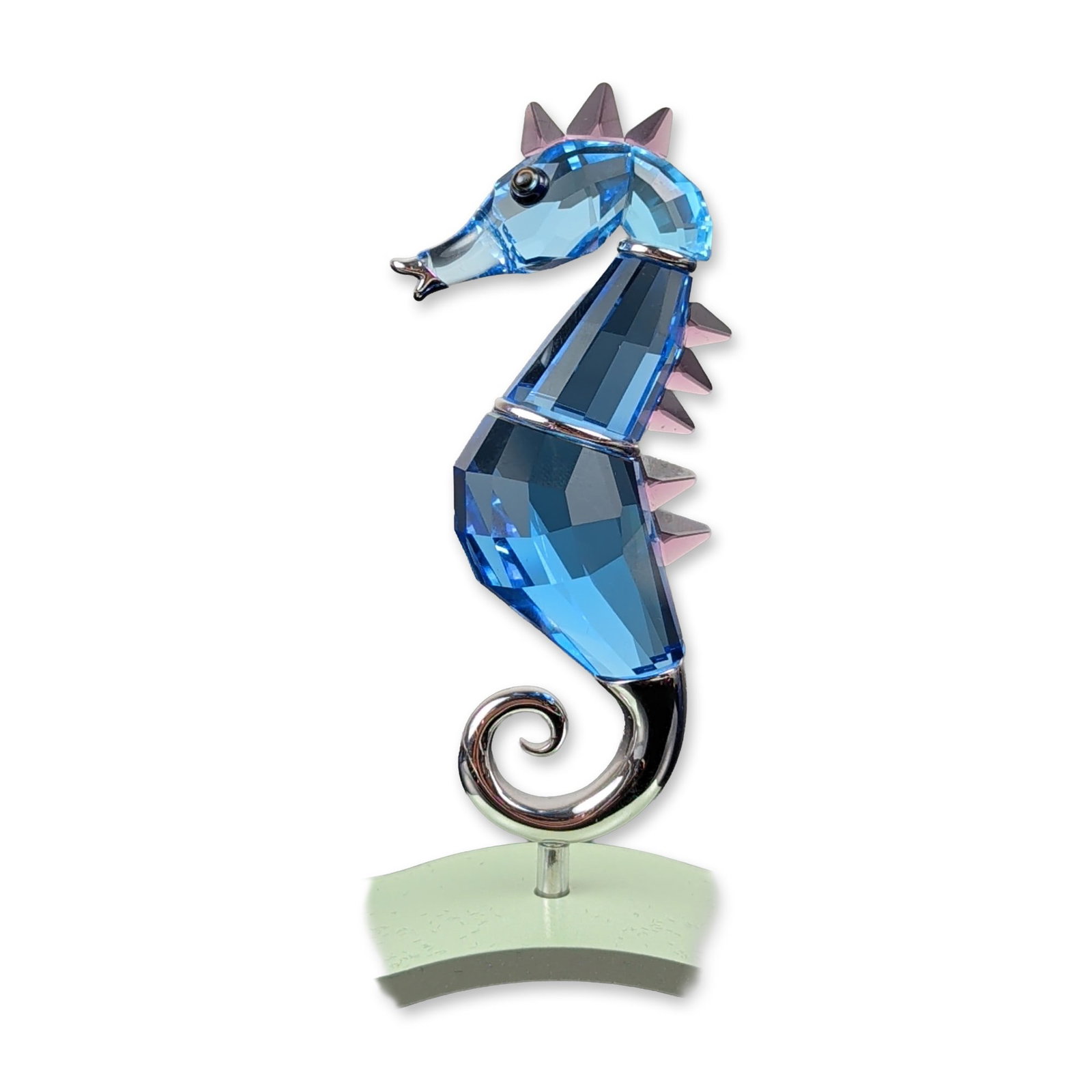 Swarovski Crystal Paradise Chipili Aquamarine Seahorse Figurine: Swarovski Crystal Paradise Chipili seahorse figurine in faceted Aquamarine crystal. The stylized figure features a multi-sectioned blue crystal body accented by iridescent purple dorsal fins and a