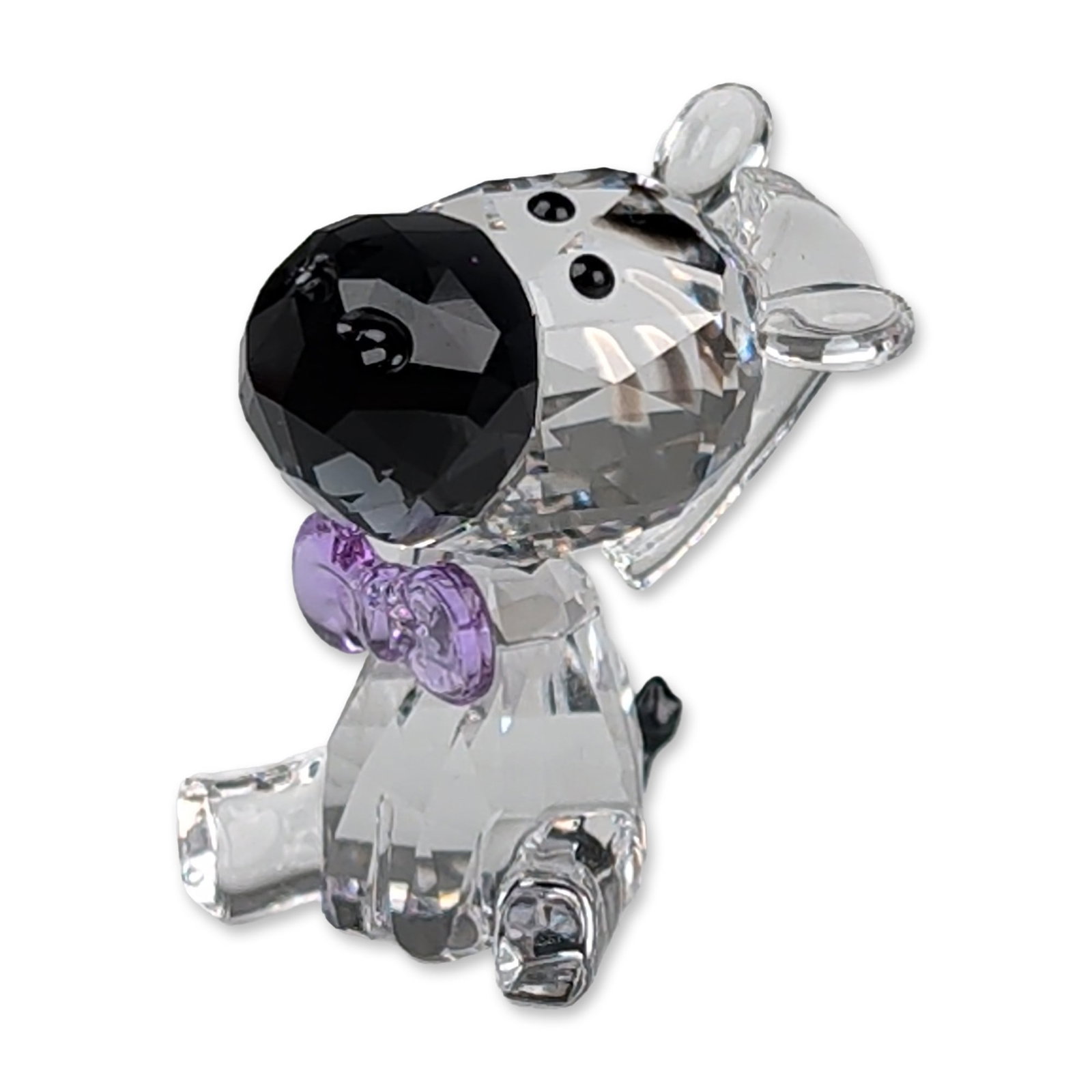 Swarovski SCS 2021 Crystal Zebra Figurine: Swarovski Zebra figurine in faceted lead crystal, featuring a clear body with black-painted head stripes, a black muzzle, a black tail, and a lavender crystal bow at the neck. The base is laser-etched