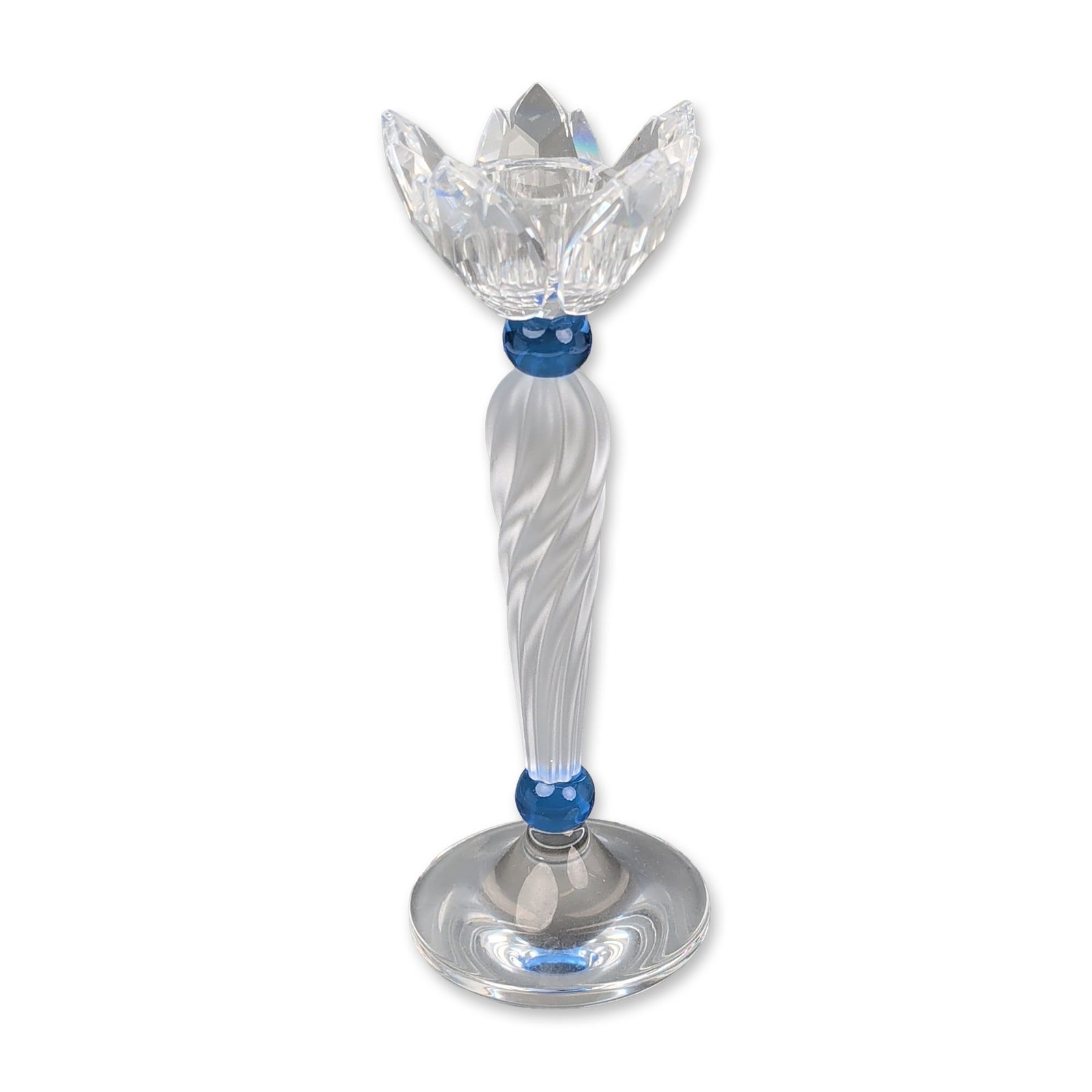 Swarovski Silver Crystal Blue Lotus Candle Holder: Swarovski Silver Crystal. Taper candle holder in lead crystal and frosted glass, featuring a faceted lotus blossom cup and a frosted twisted glass stem accented by two sapphire blue spacer beads. An e